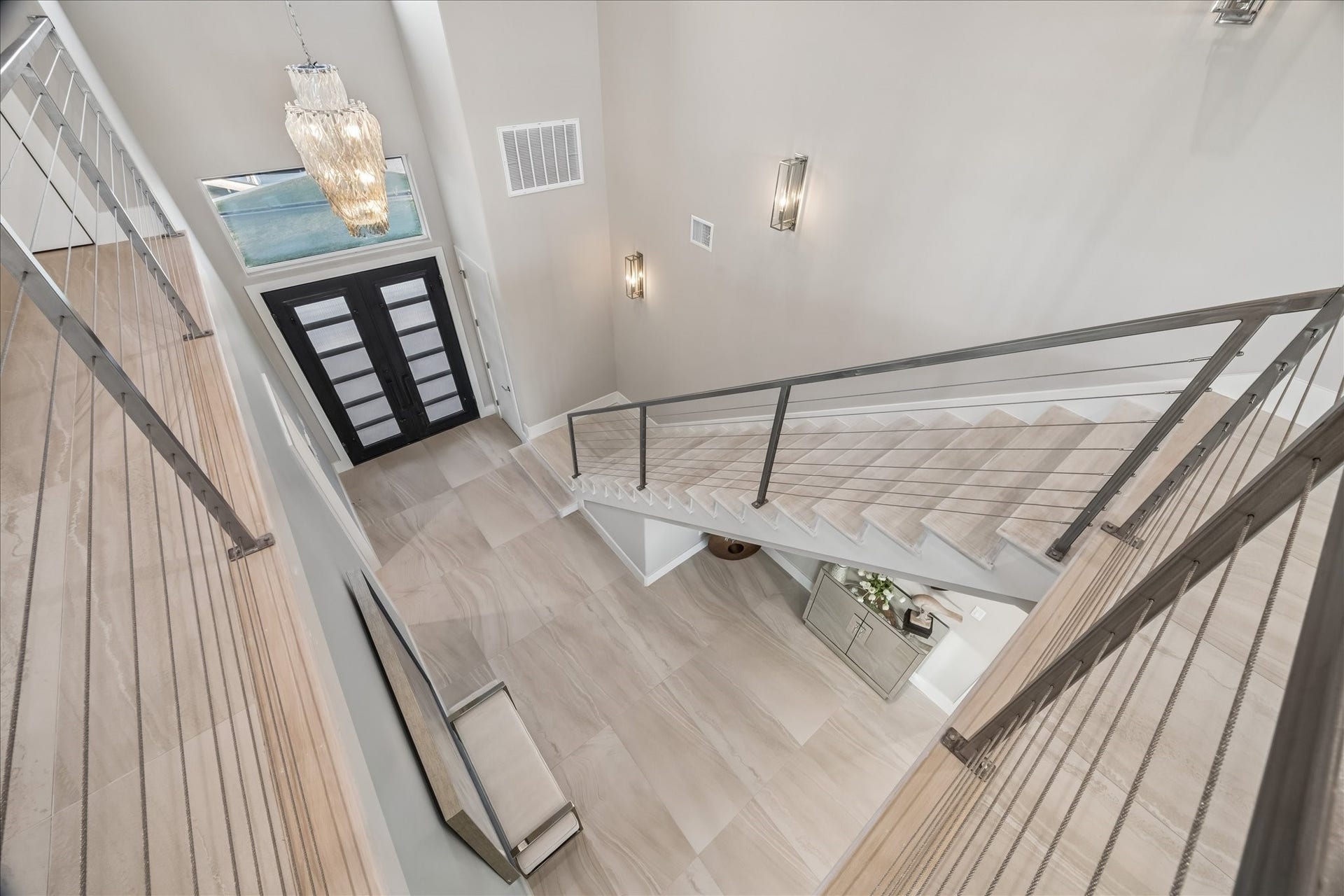 1 Water Key, Hitchcock, TX 77563 A beautiful chandelier and sleek cable-railing staircase anchor this grand, light-filled foyer, leading to the second-level living area with three additional guest bedrooms, full bathrooms, and a spacious outdoor balcony