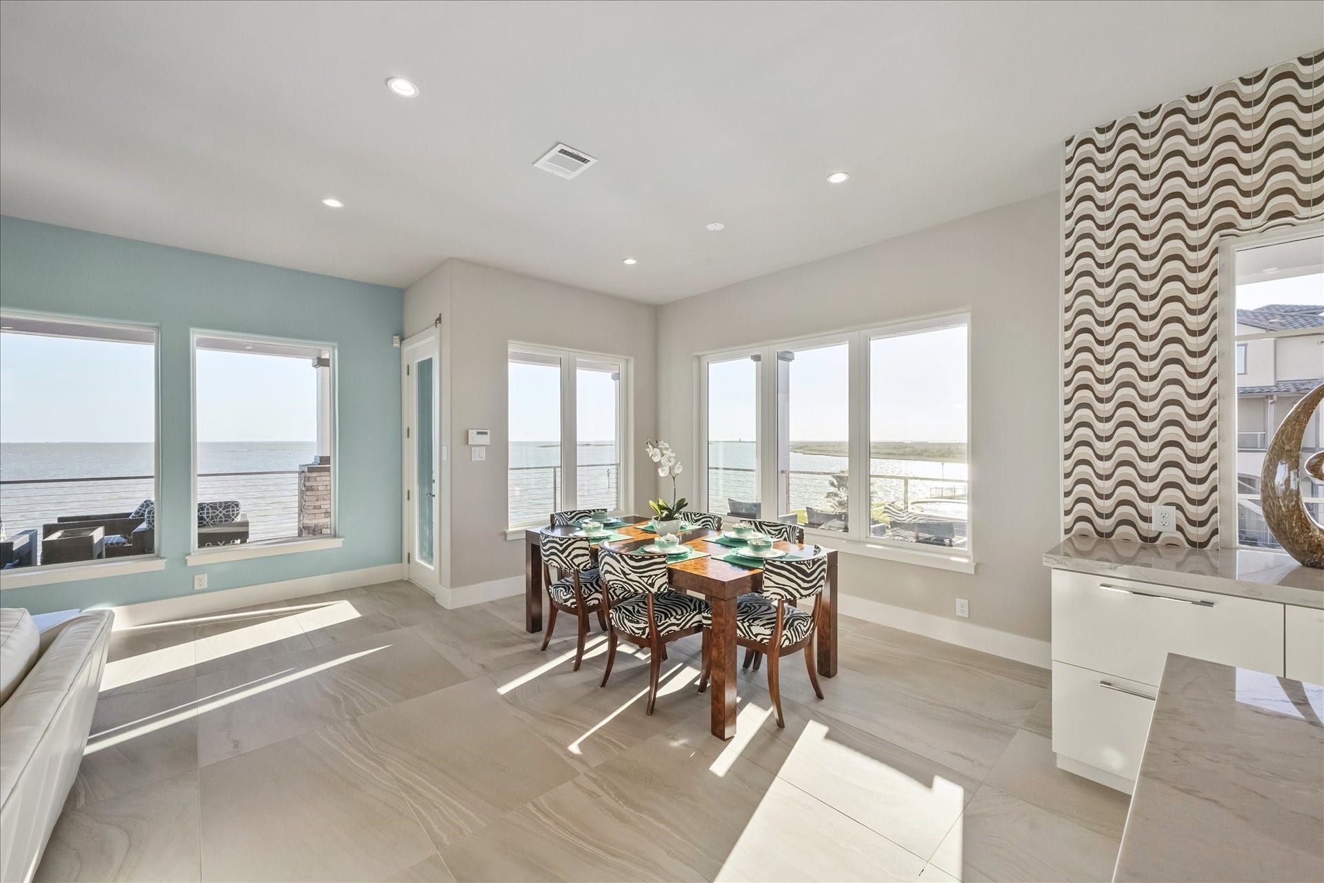 1 Water Key, Hitchcock, TX 77563 The dining room flows seamlessly with the kitchen and living room, offering a natural connection to the outdoors and ample space for a large gatherings