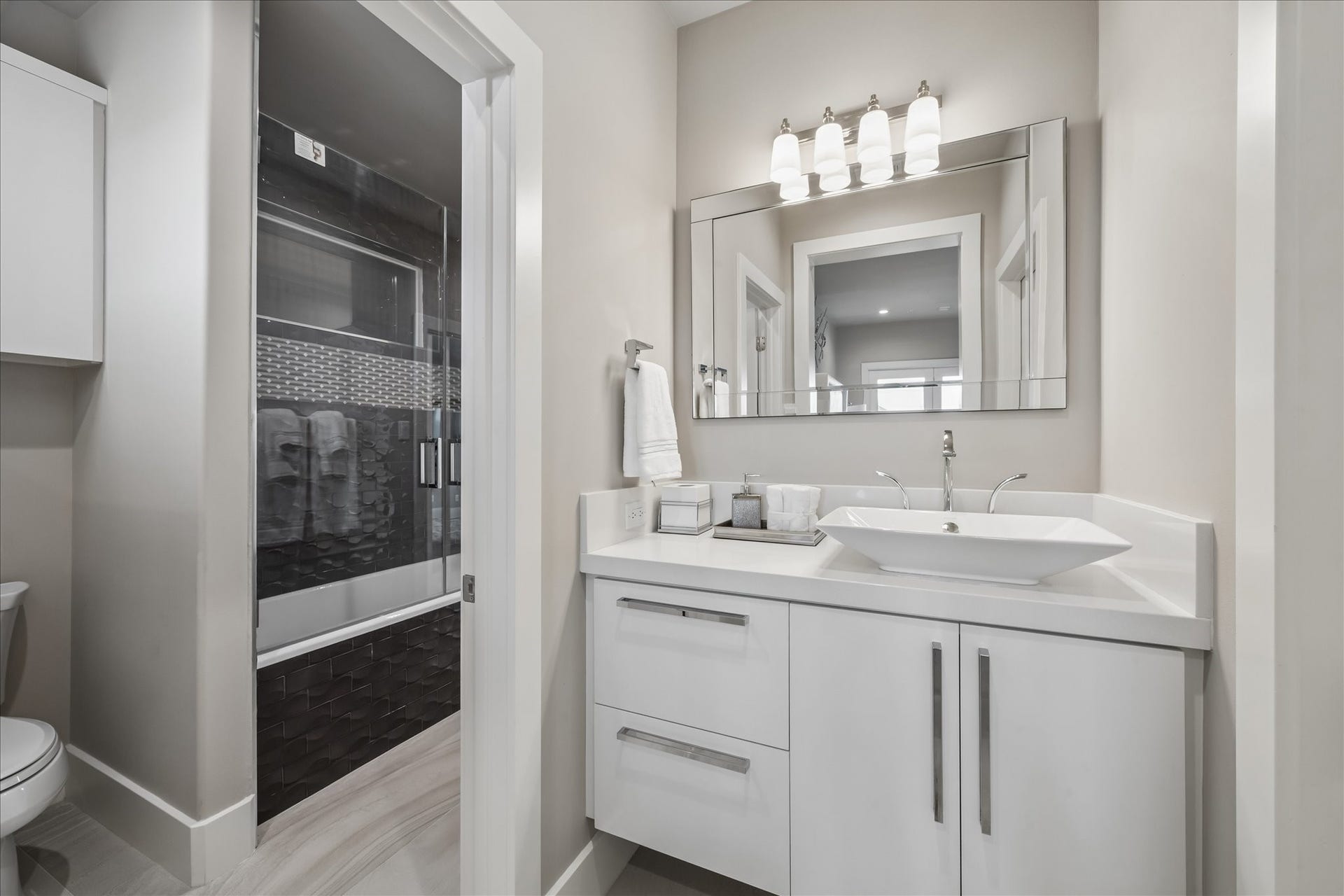 1 Water Key, Hitchcock, TX 77563 The other side of the Jack & Jill bathroom includes access to the spacious tub/shower, modern fixtures, and a coordinating quartz countertop with under-vanity lighting, offering both style and functionality for the adjoining bedroom