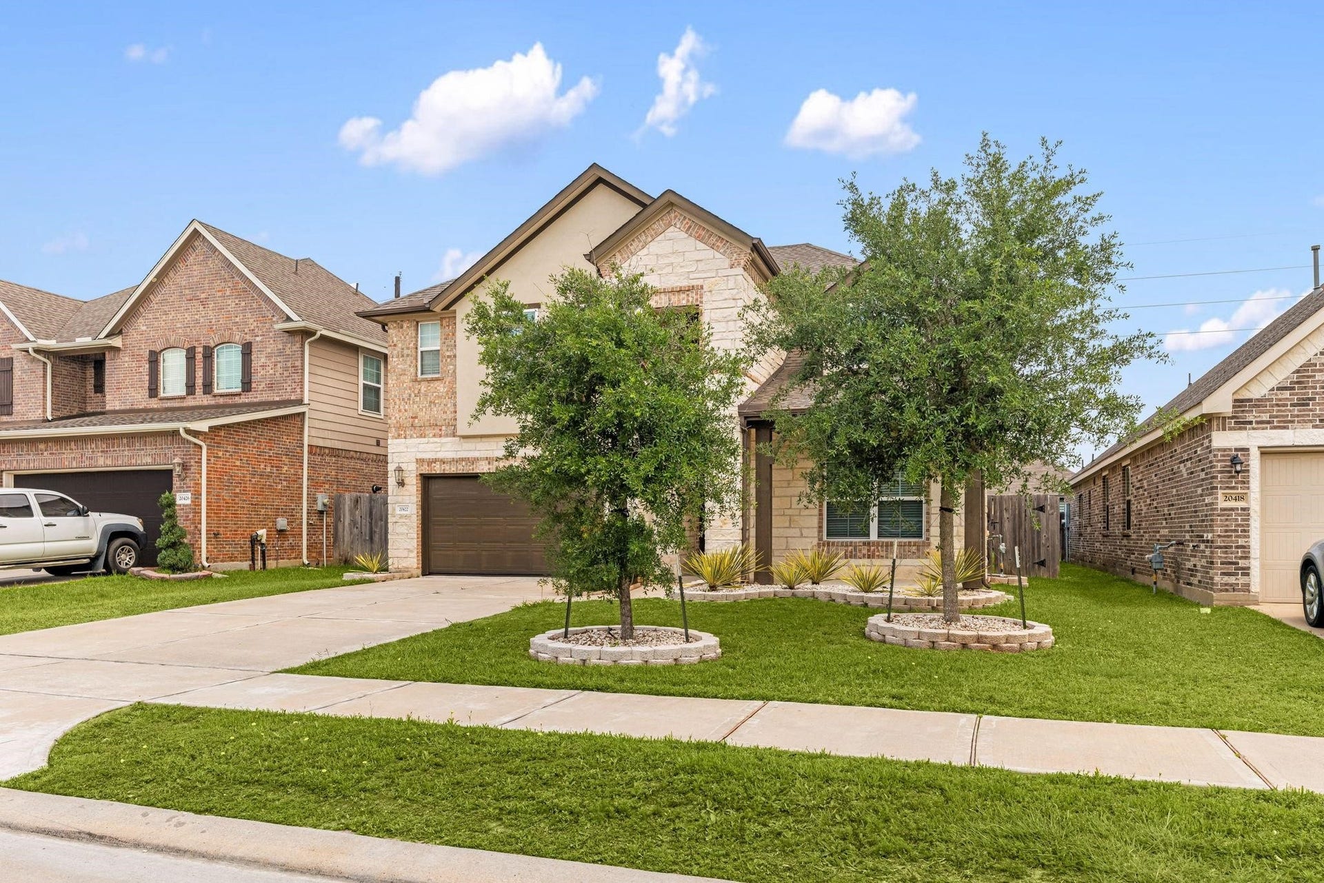 20422 Alpine Meadow Place, Richmond, TX 77407 Green grass and young shade trees give the home fantastic curb appeal as you pull up.