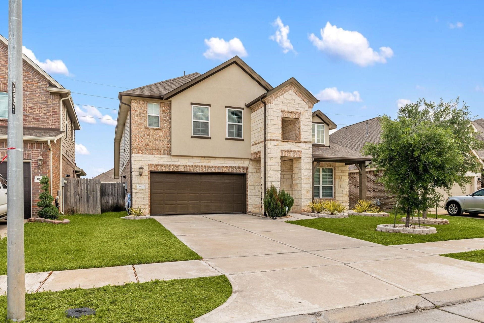 20422 Alpine Meadow Place, Richmond, TX 77407 A wide driveway offers plenty of parking space leading up to the two-car garage.