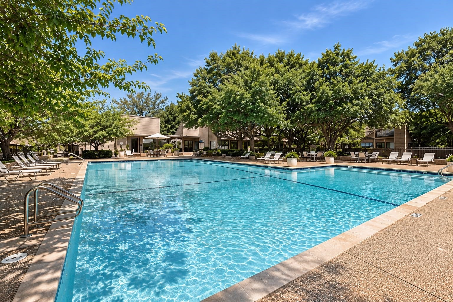 1402 Chardonnay Drive, Houston, TX 77077 Resort-style community swimming pool surrounded by lounge seating, mature trees, and relaxing outdoor spaces.
