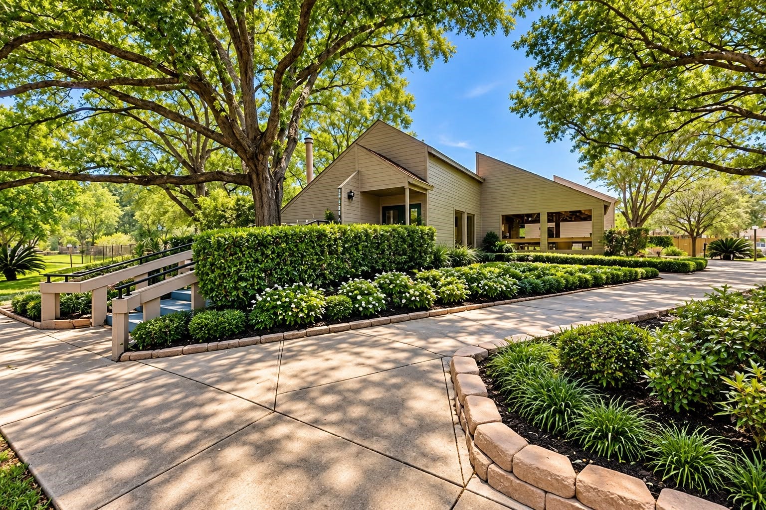 1402 Chardonnay Drive, Houston, TX 77077 Welcoming clubhouse exterior with landscaped walkways, lush greenery, and inviting outdoor spaces.