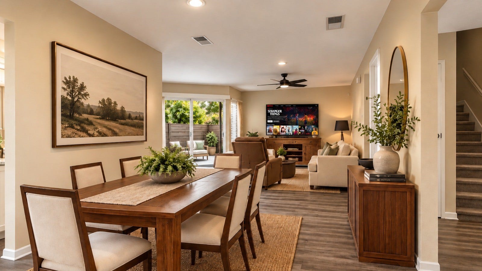 1402 Chardonnay Drive, Houston, TX 77077 Open-Concept Living and Dining Area: Bright open-concept living and dining space featuring wood-look flooring, a dedicated dining area, sliding glass doors, and a seamless flow for everyday living and entertaining.