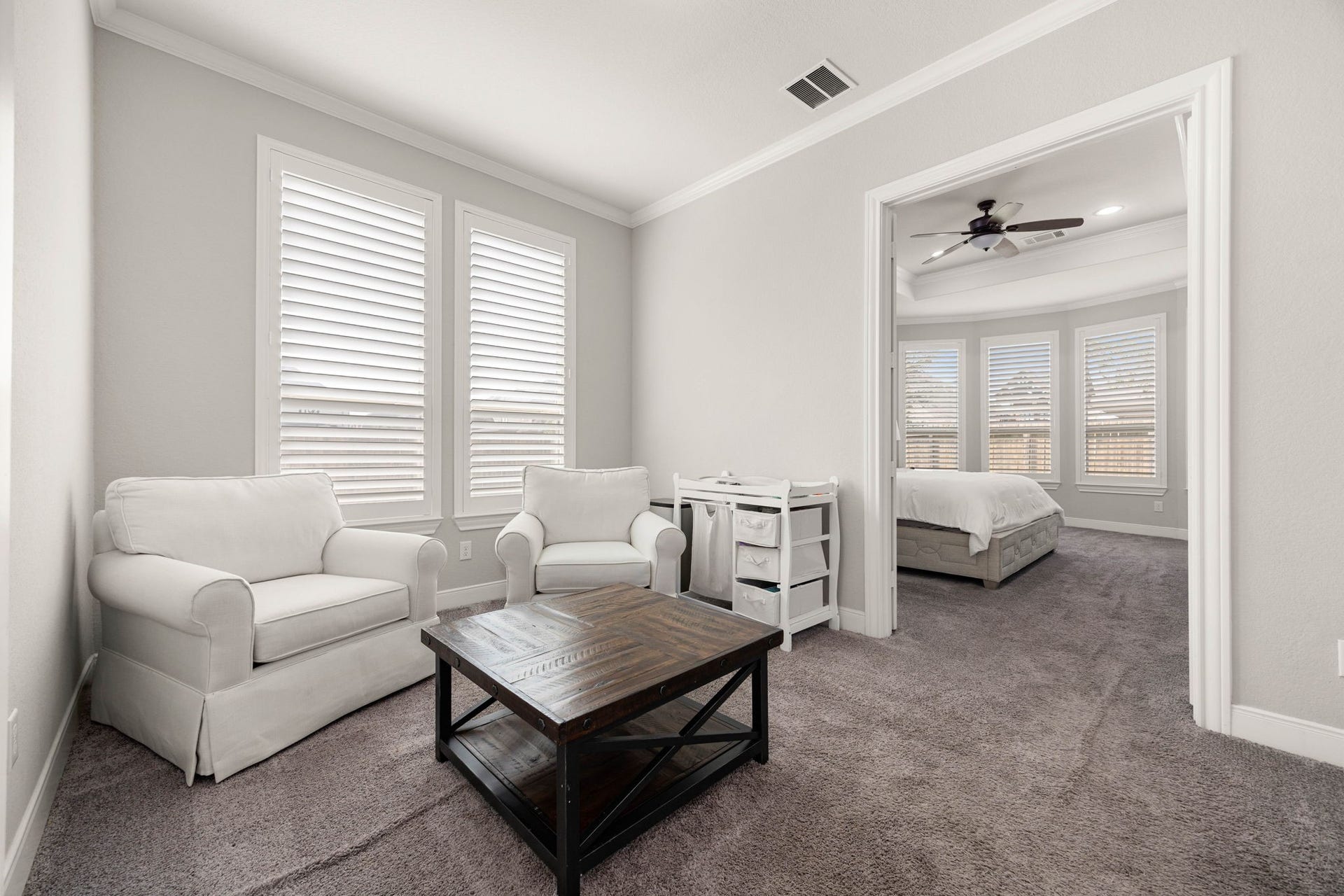 A cozy sitting area just off the primary bedroom provides a flexible space for relaxing or unwinding.