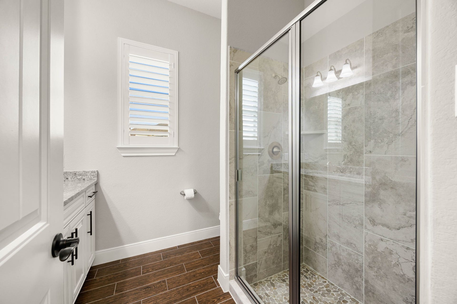 This secondary bathroom features a walk-in shower and a clean, updated vanity for easy everyday use.