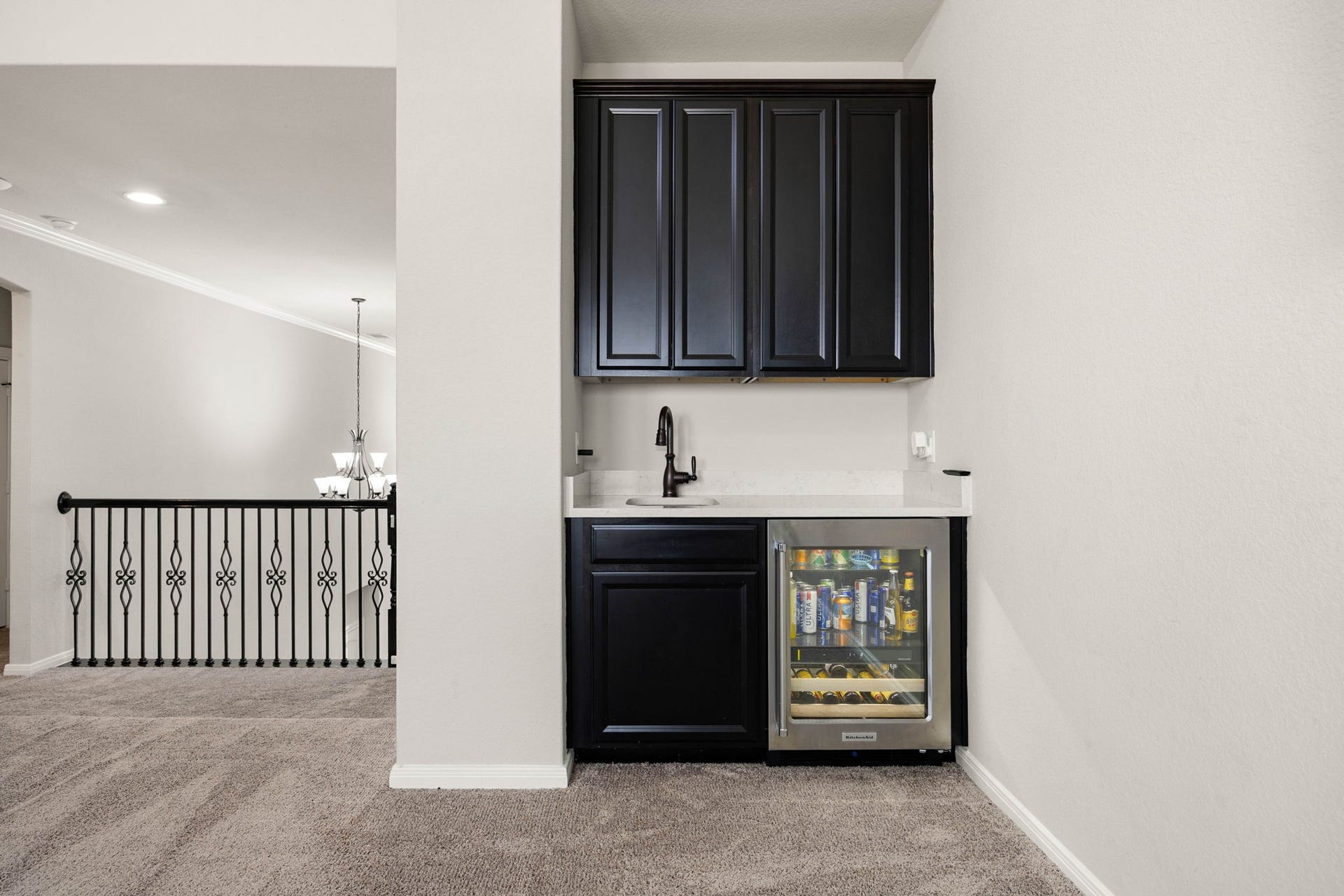 Just off the game room, a dedicated wet bar with beverage fridge and sink keeps drinks and snacks close by.