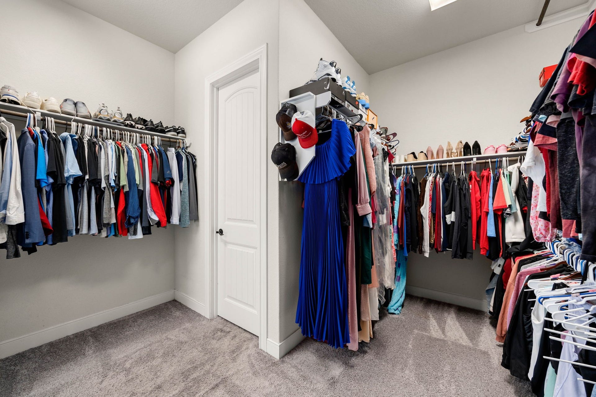 The spacious walk-in closet offers ample storage for clothing and accessories.