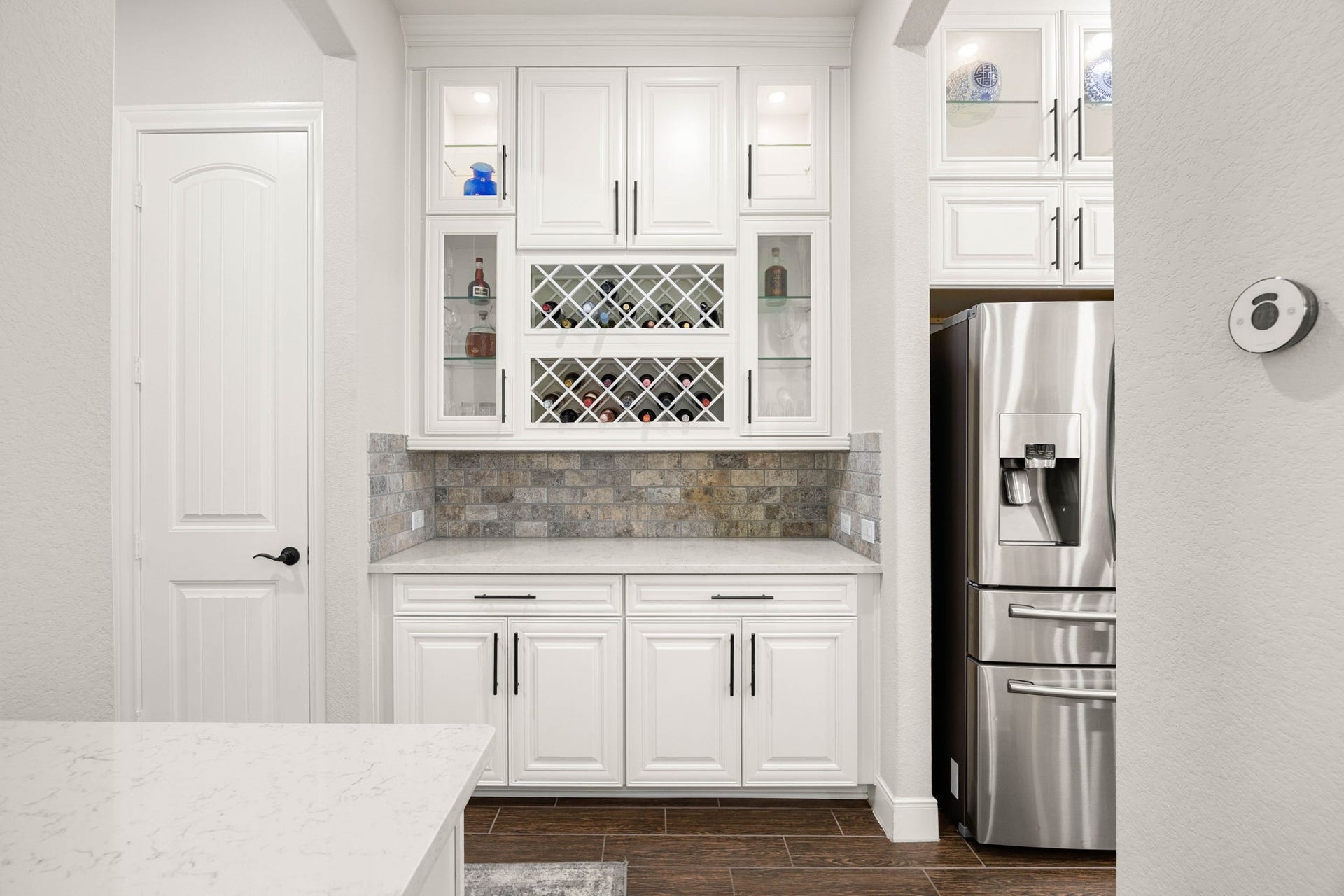 Just off the kitchen, the butler's pantry adds glass-front cabinetry, counter space and built-in wine storageready for entertaining without crowding the kitchen.