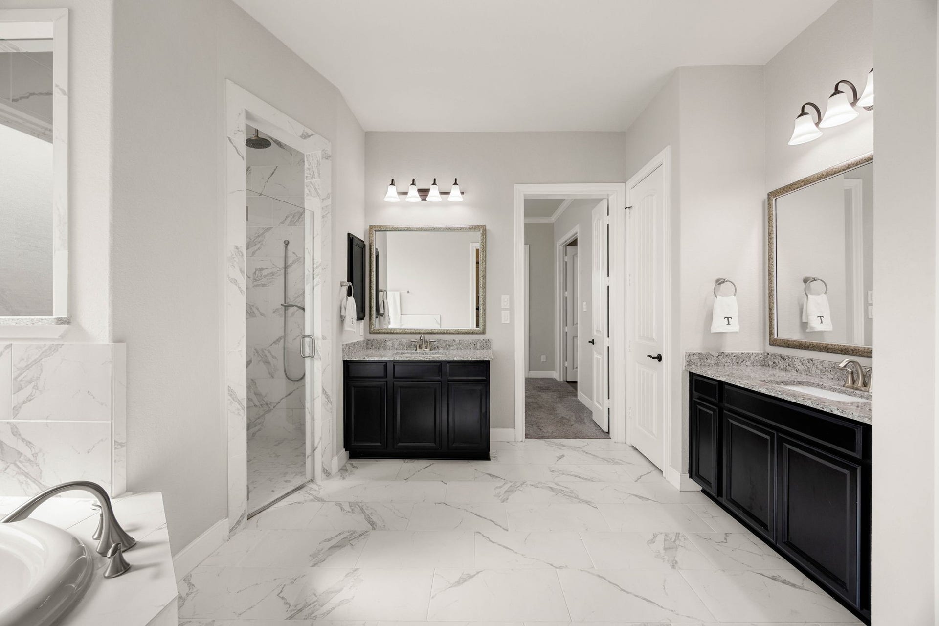 The spacious primary bath keeps things clean and bright with dual vanities, a soaking tub and plenty of natural light.