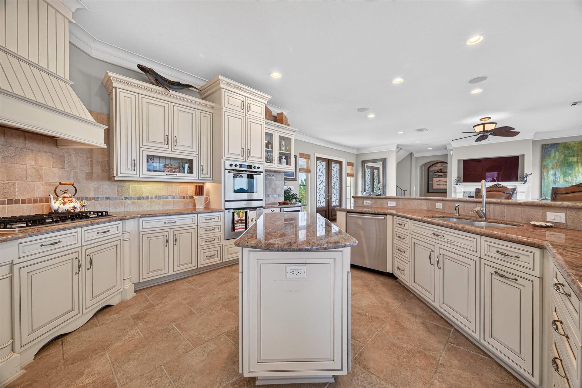 13 Sugarloaf, Hitchcock, TX 77563 Elegant kitchen featuring custom cabinetry, granite countertops, and a spacious center island, perfect for entertaining and culinary adventures.