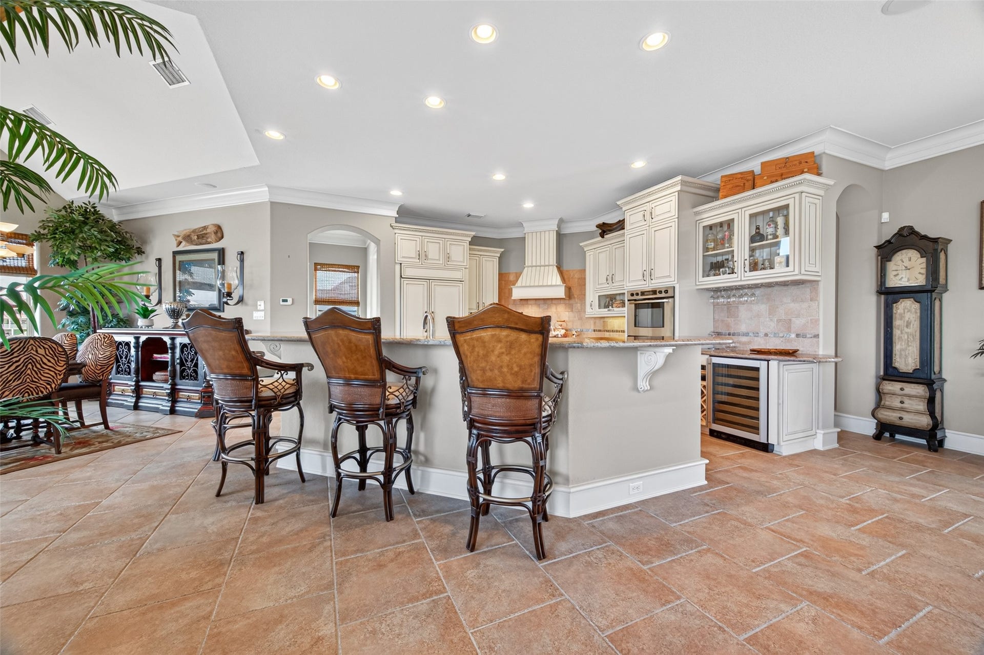 13 Sugarloaf, Hitchcock, TX 77563 Spacious kitchen with elegant bar seating, custom cabinetry, and built-in appliances, offering a perfect blend of style and functionality.