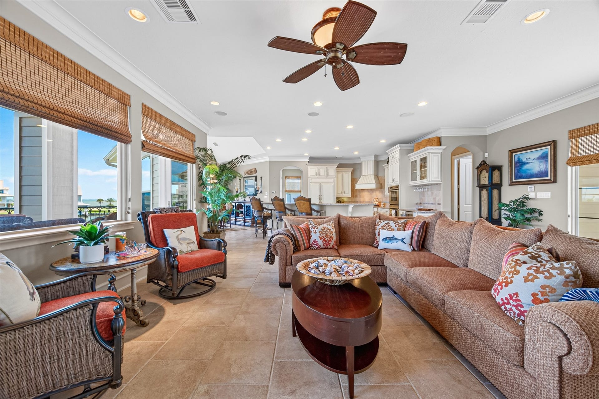 13 Sugarloaf, Hitchcock, TX 77563 Spacious open-concept living area with abundant natural light, featuring a cozy sectional sofa, elegant ceiling fan, and a seamless flow into the modern kitchen, perfect for entertaining.