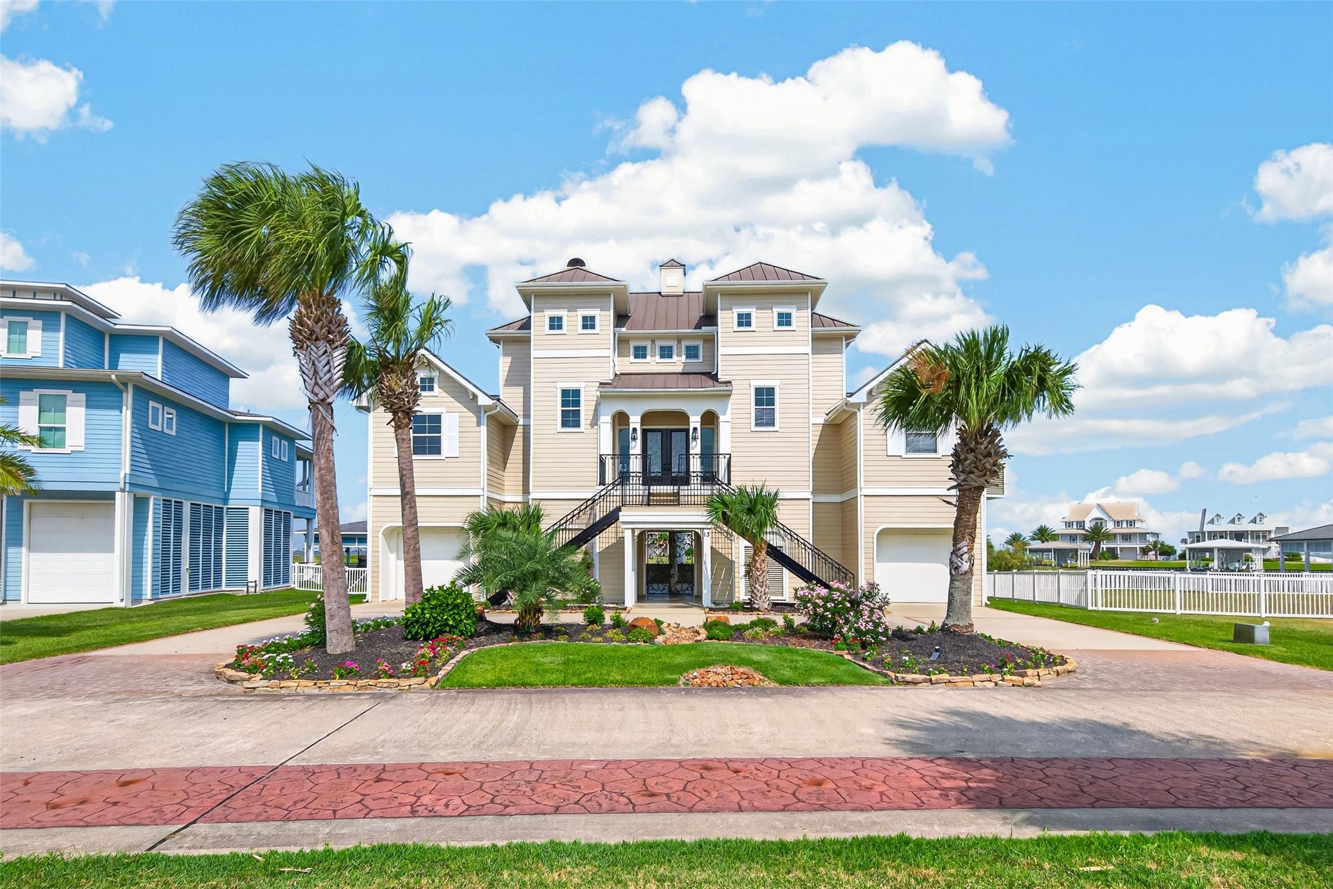 13 Sugarloaf, Hitchcock, TX 77563 Stunning coastal home with elevated design, beautiful landscaping, and charming architectural features, perfect for seaside living.