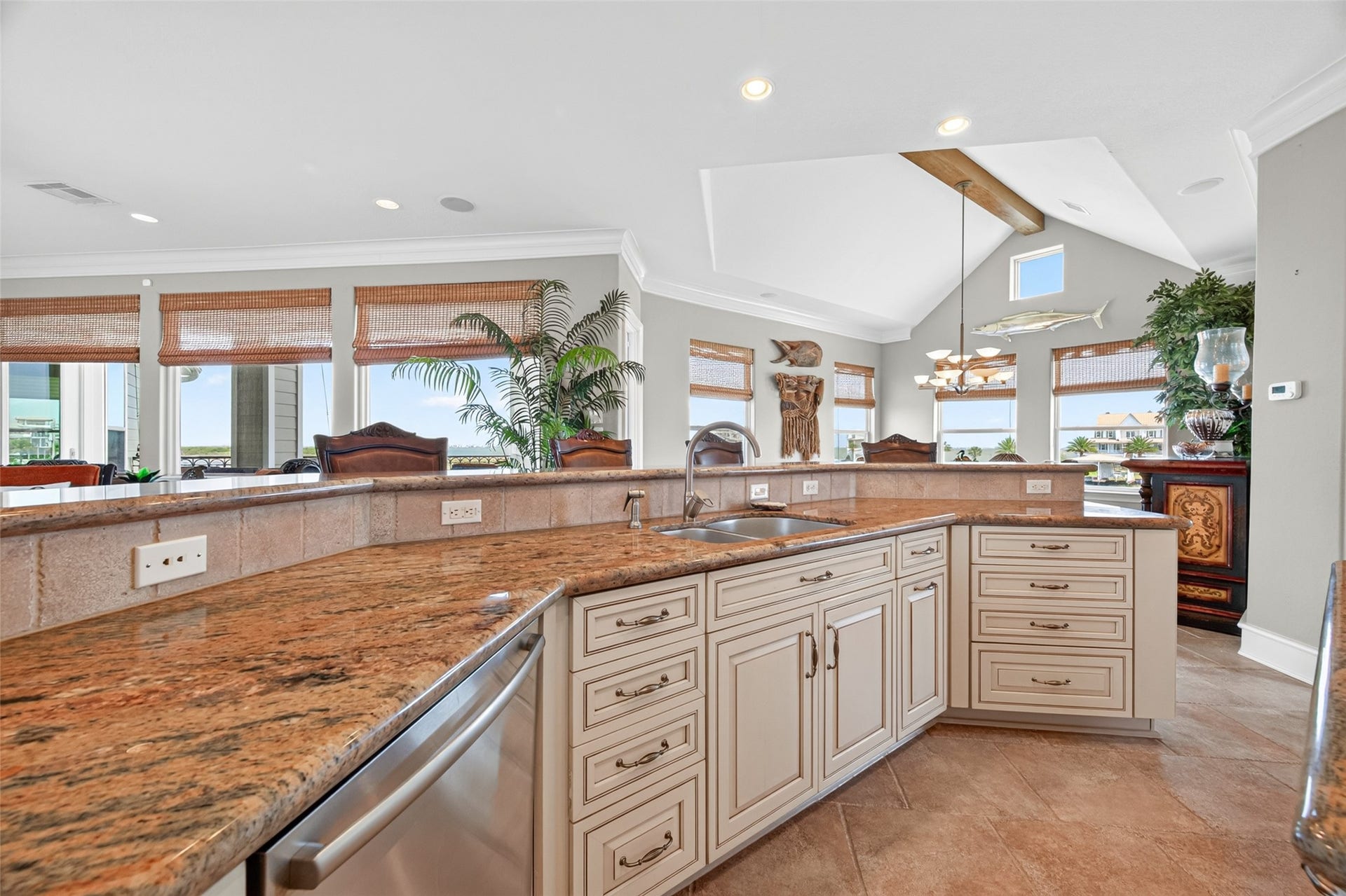 13 Sugarloaf, Hitchcock, TX 77563 Spacious kitchen with elegant granite countertops, custom cabinetry, and a convenient double sink, complemented by abundant natural light and an open layout perfect for entertaining.