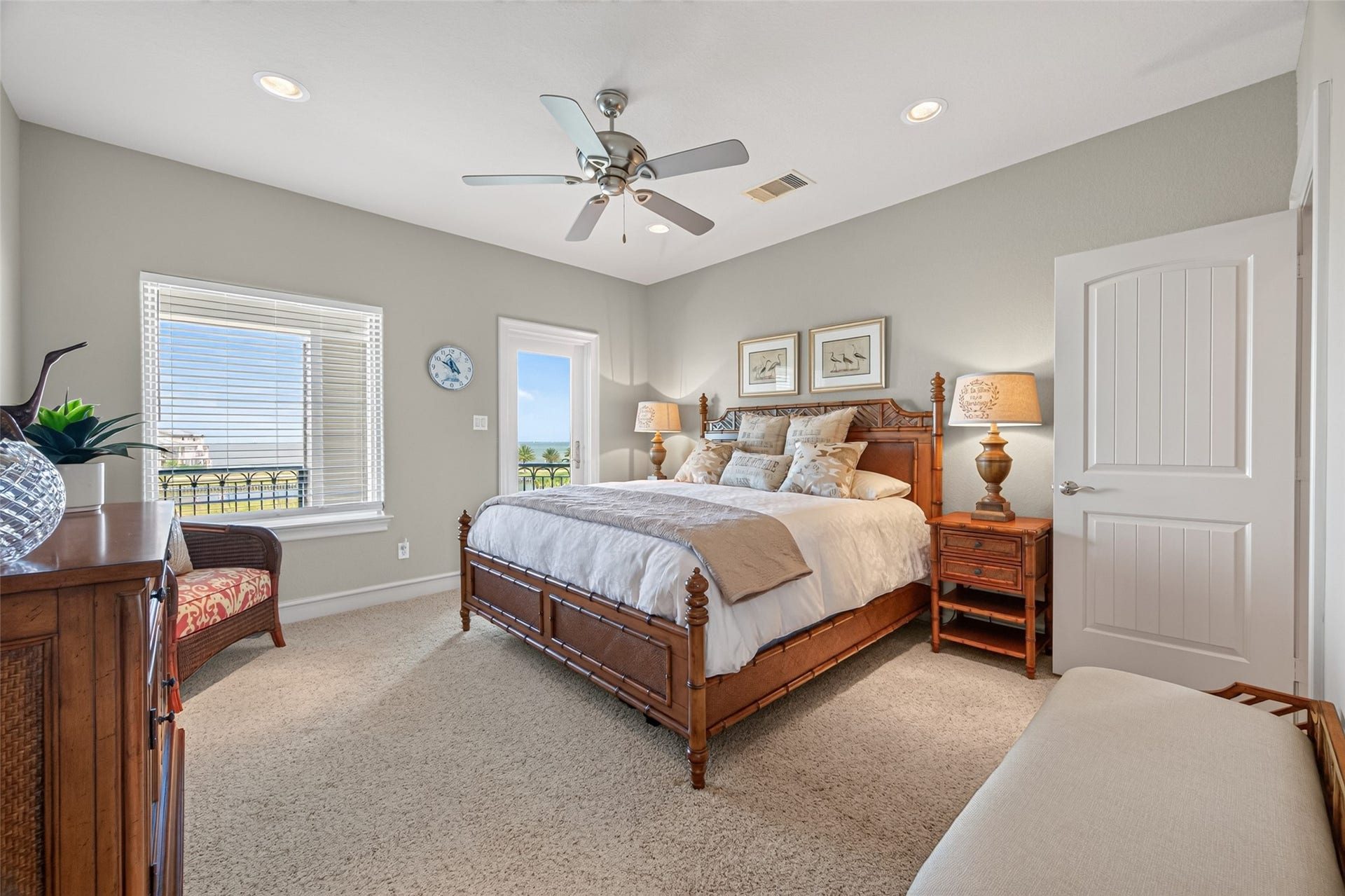 13 Sugarloaf, Hitchcock, TX 77563 Inviting bedroom with abundant natural light, featuring a cozy bed, elegant wooden furniture, and a calming neutral palette.