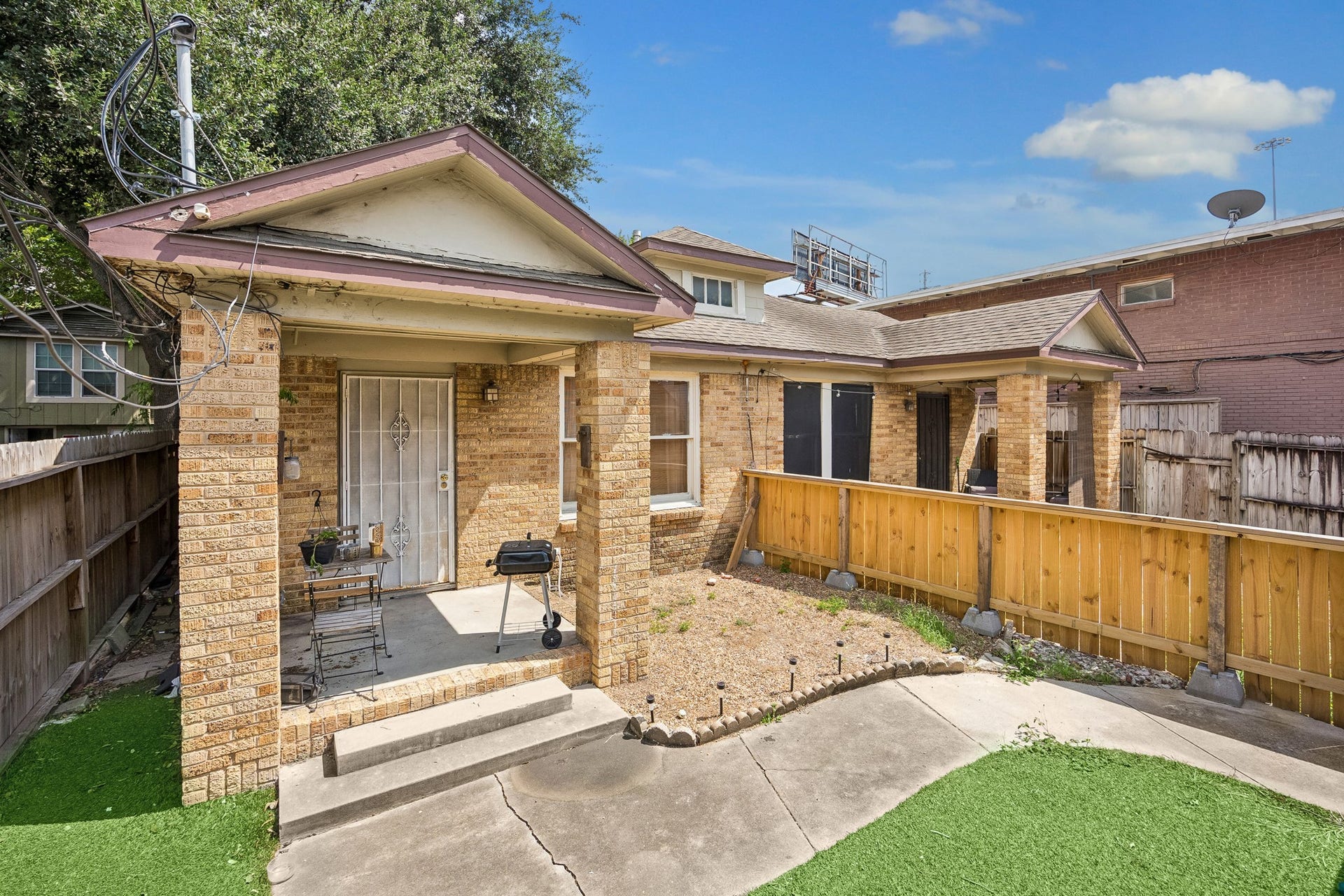 The front duplex features two units, each with a private porch and yard.