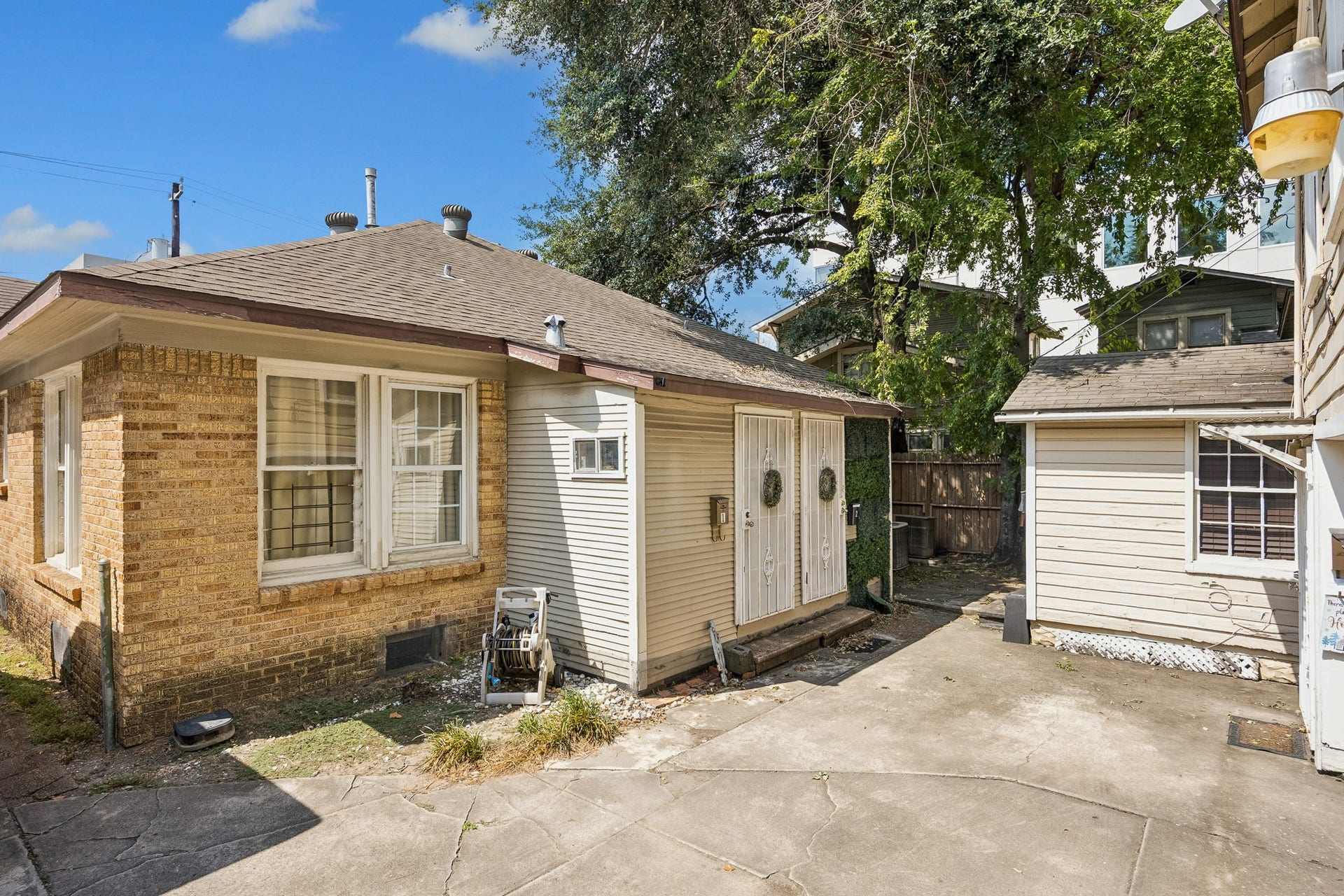 The entrances to the duplex units are located near the parking space.