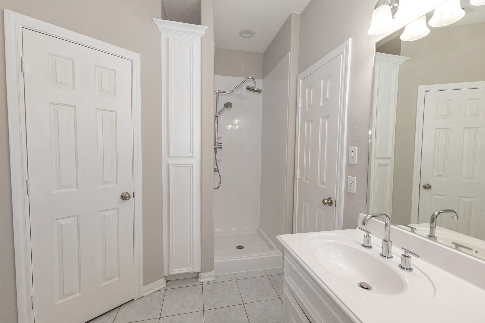 3302 Royal Oaks Drive, Spring, TX 77380 The primary bathroom offers a separate walk-in shower with dual showerheads, and built-in storage. Bright, neutral finishes create a clean, refreshing space!