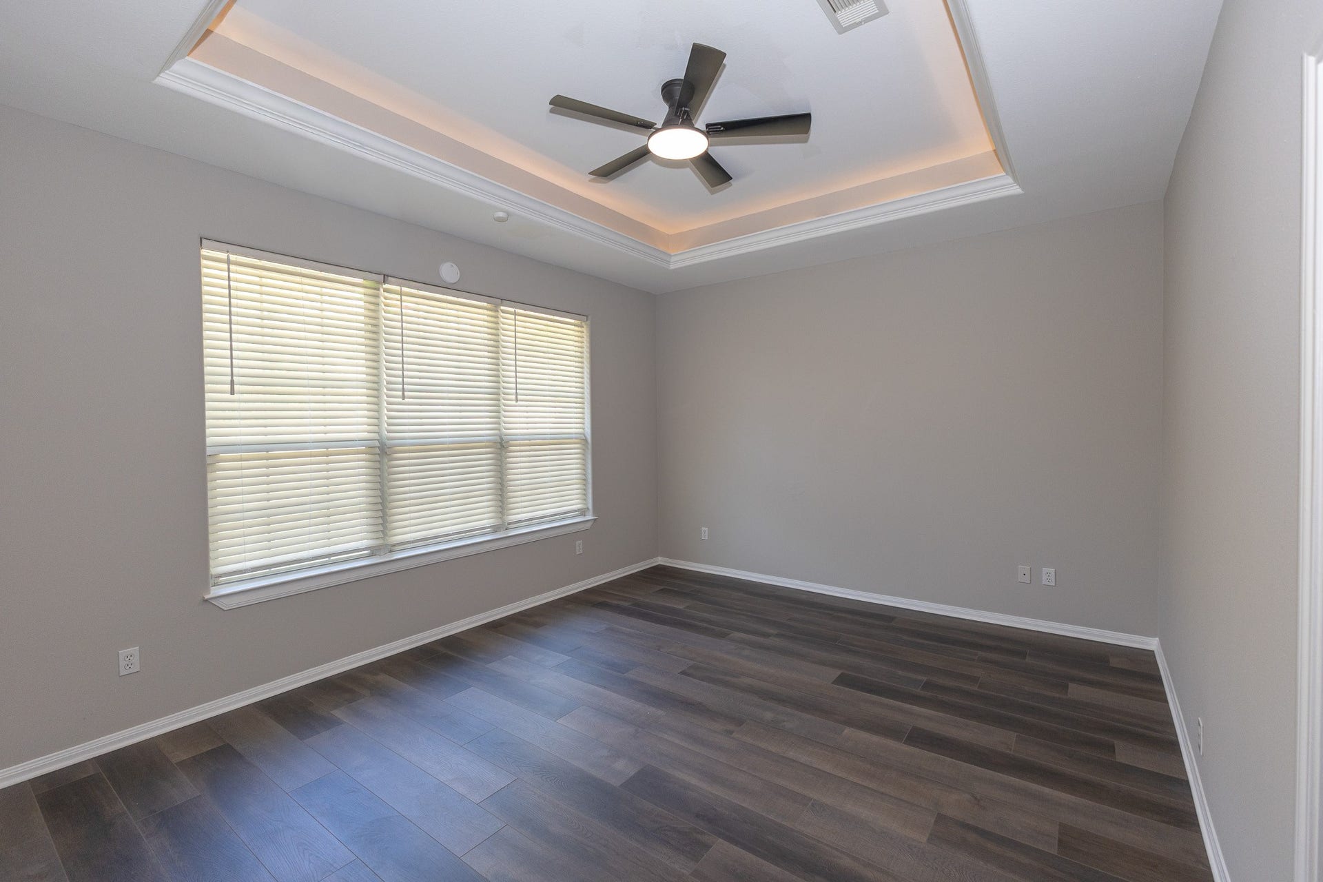 3302 Royal Oaks Drive, Spring, TX 77380 Spacious primary bedroom featuring beautiful new flooring, fresh neutral paint, and an elegant tray ceiling with soft accent lighting. Large windows fill the room with natural light, creating a peaceful retreat to unwind at the end of the day!