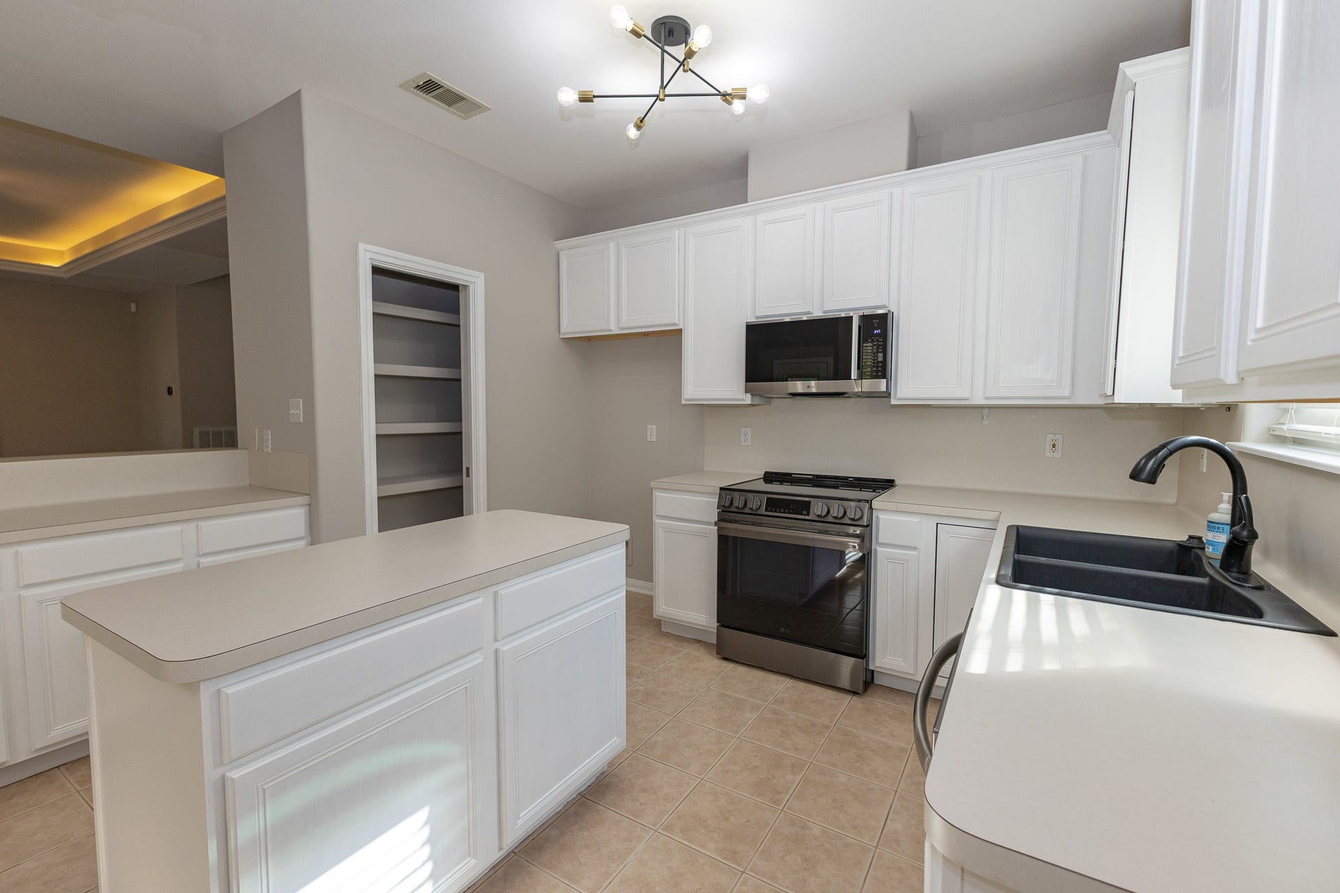 3302 Royal Oaks Drive, Spring, TX 77380 Bright, inviting kitchen featuring a new stove and microwave! Generous counter space and a convenient pantry provide plenty of storage and everyday functionality!