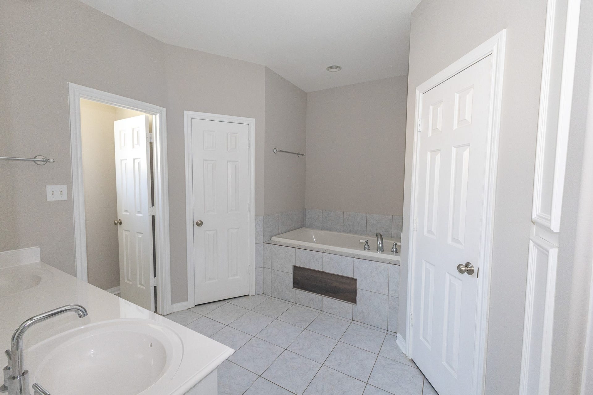 3302 Royal Oaks Drive, Spring, TX 77380 Inviting primary bathroom featuring a spacious vanity, soothing neutral tones, and a soaking tub perfect for unwinding after a long day. Thoughtfully designed with comfort and functionality in mind with his and her walk-in closets!