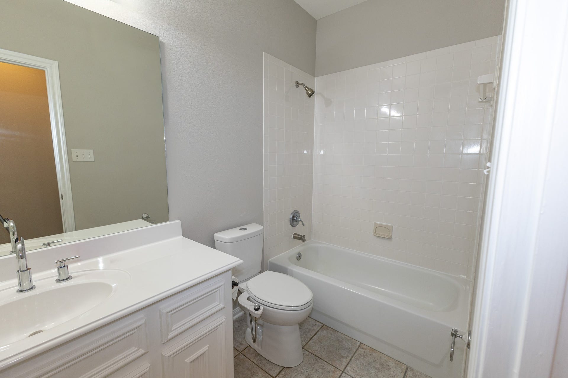 3302 Royal Oaks Drive, Spring, TX 77380 Bright and inviting guest bathroom featuring a spacious vanity, large mirror, and a tub/shower combination!
