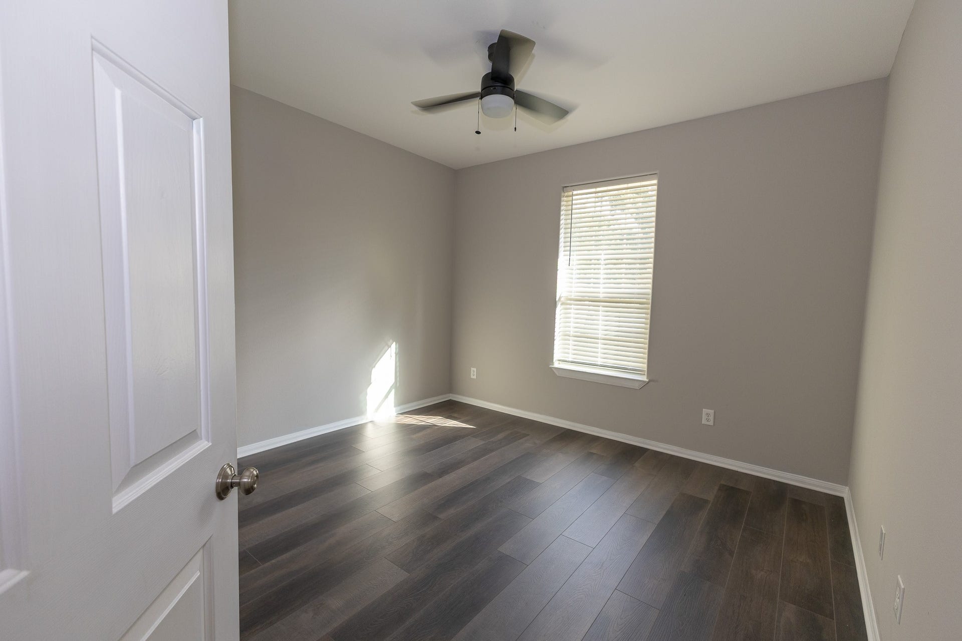 3302 Royal Oaks Drive, Spring, TX 77380 Bright and versatile second bedroom featuring beautiful new flooring, fresh neutral paint, and a modern ceiling fan. Natural light creates a welcoming space, perfect for guests, family, or a home office!