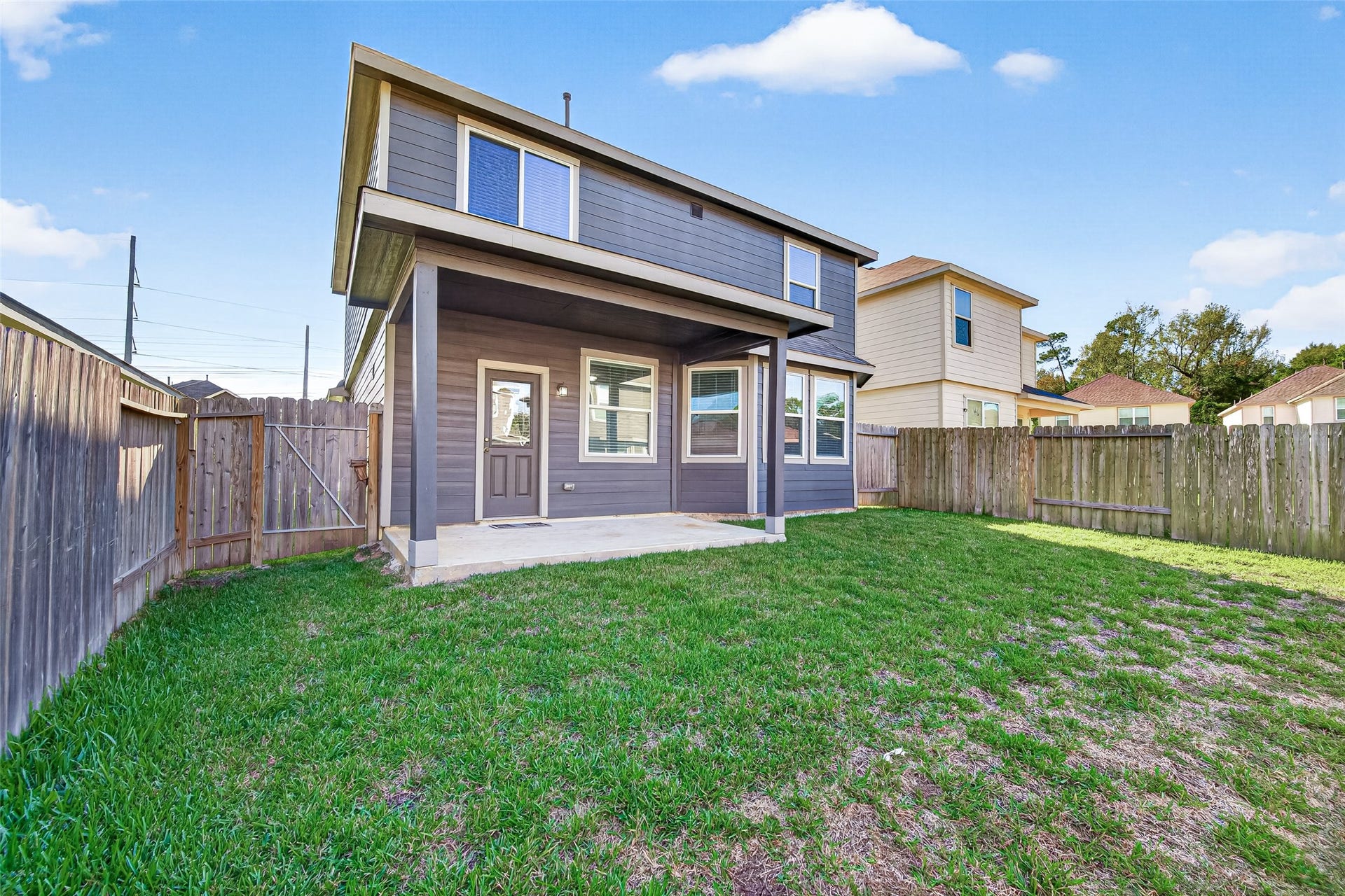 13405 Cannon Creek Court, Willis, TX 77378 Fenced backyard with a covered patio, perfect for outdoor entertaining and relaxation.
