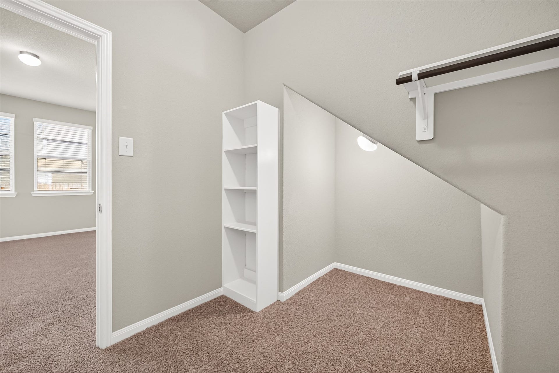 13405 Cannon Creek Court, Willis, TX 77378 Cozy nook with built-in shelving and a hanging rod, perfect for extra storage.
