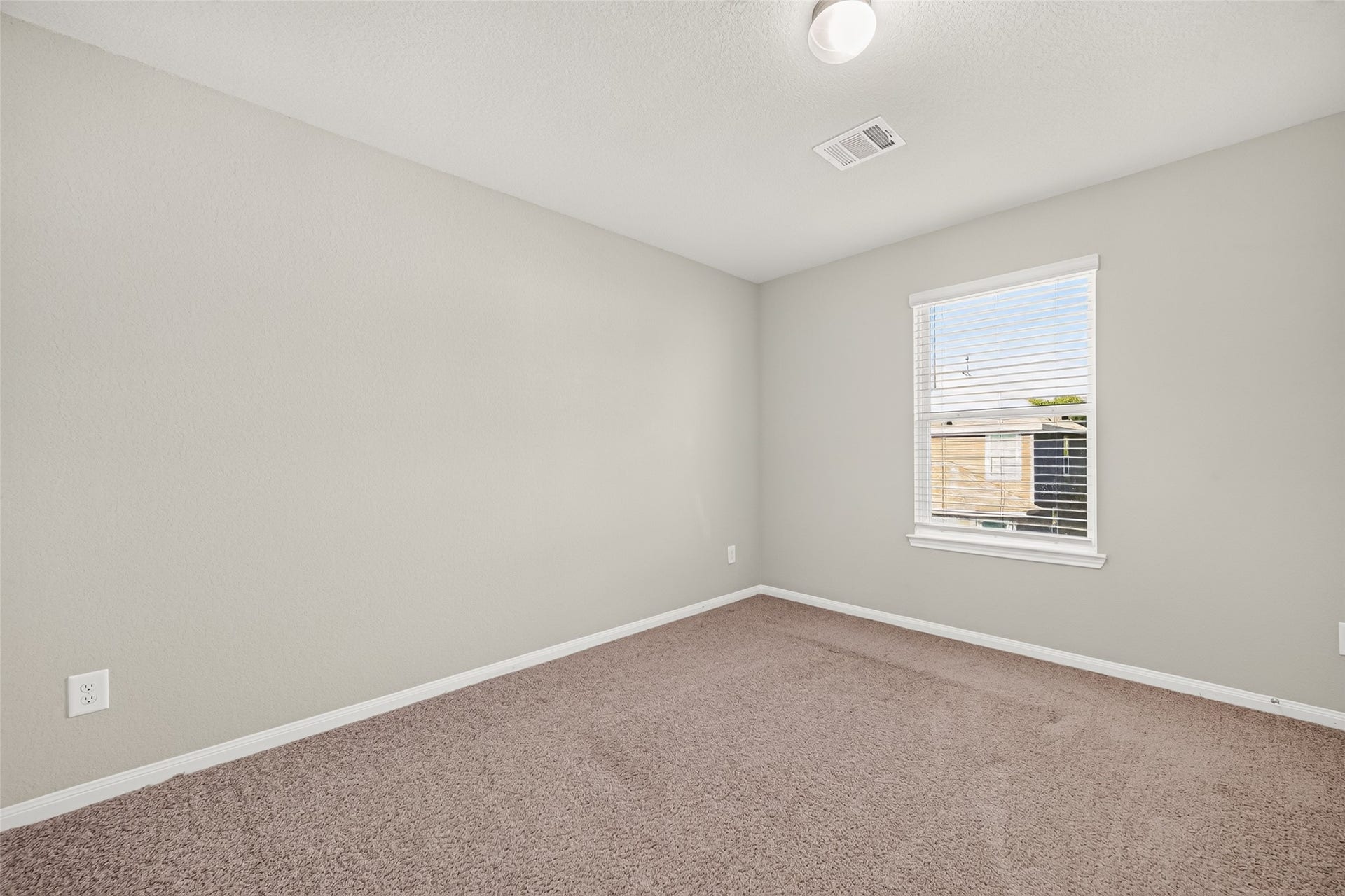 13405 Cannon Creek Court, Willis, TX 77378 Bedroom 2 bright and airy bedroom with soft carpeting, neutral walls, and a large window for natural light.