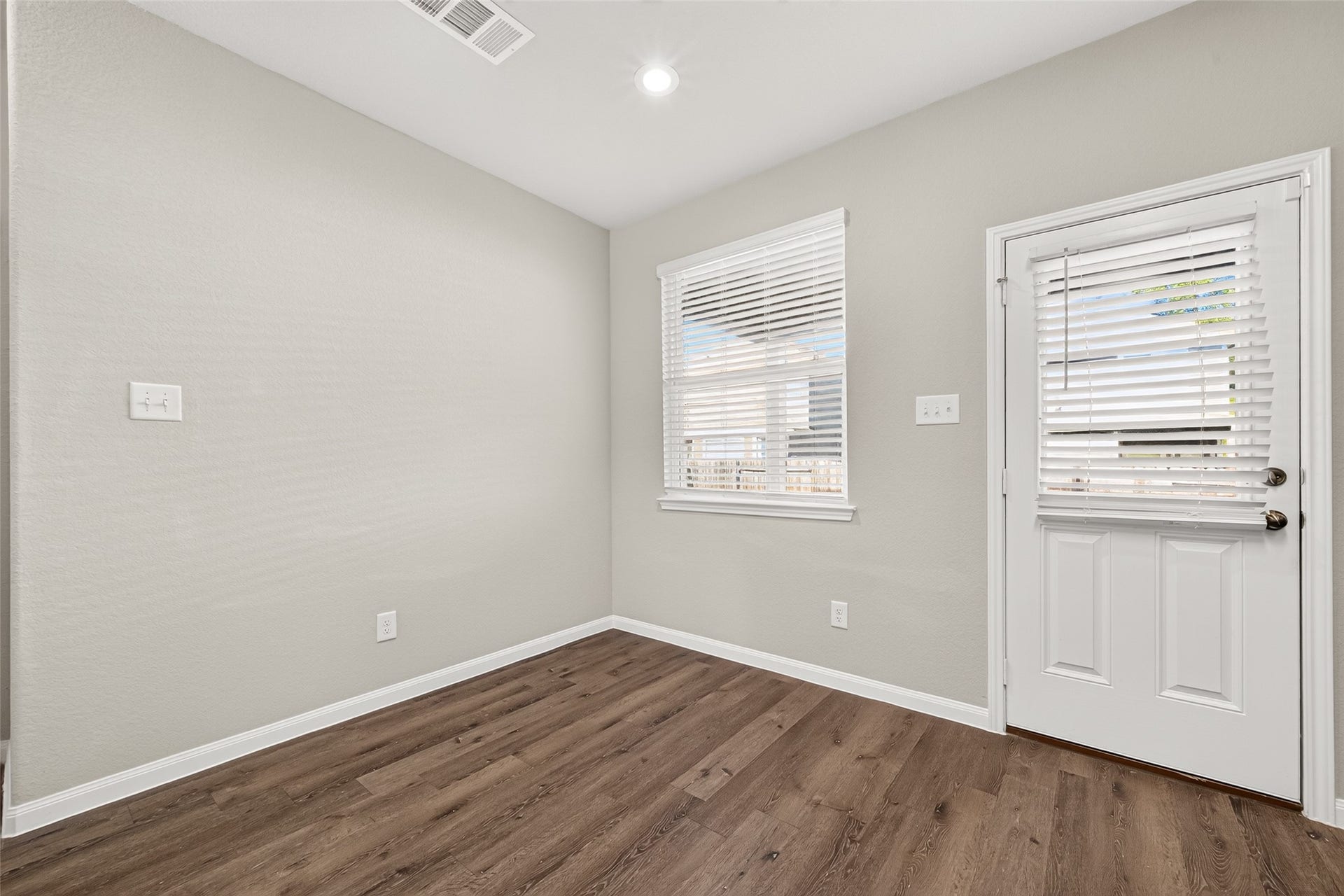 13405 Cannon Creek Court, Willis, TX 77378 Breakfast area featuring vinyl plank flooring, neutral walls, and ample natural light through a window and glass-paneled door.
