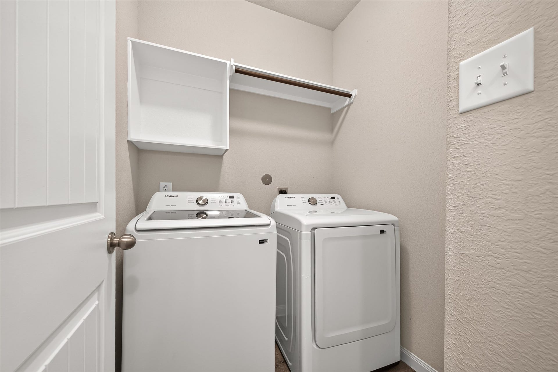 13405 Cannon Creek Court, Willis, TX 77378 Laundry room equipped with modern Samsung washer and dryer, complemented by convenient shelving for storage.