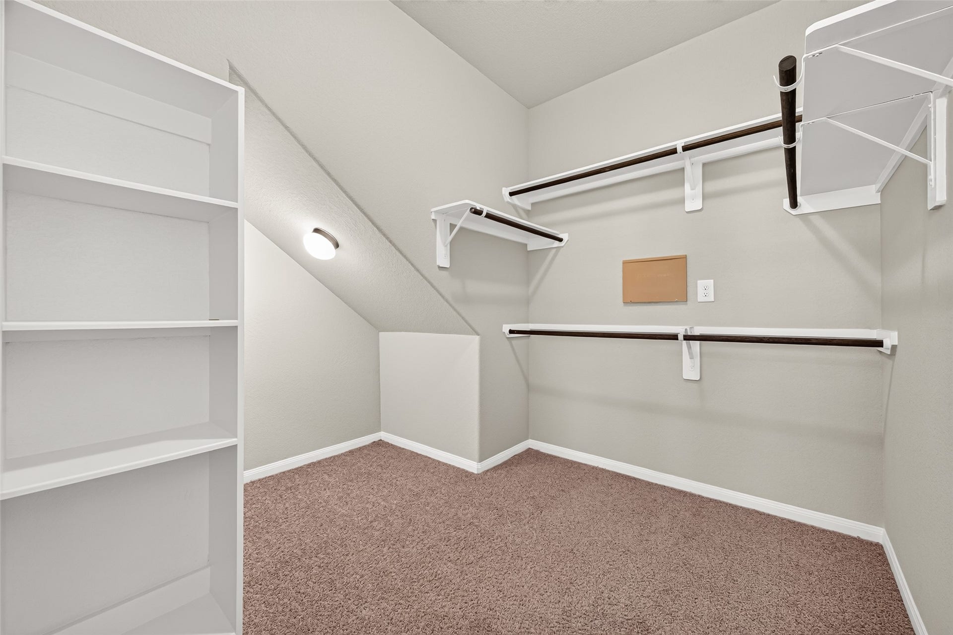 13405 Cannon Creek Court, Willis, TX 77378 WOW look at this Spacious walk-in closet with ample shelving and hanging space, carpeted flooring, and soft lighting for a cozy and functional storage area.