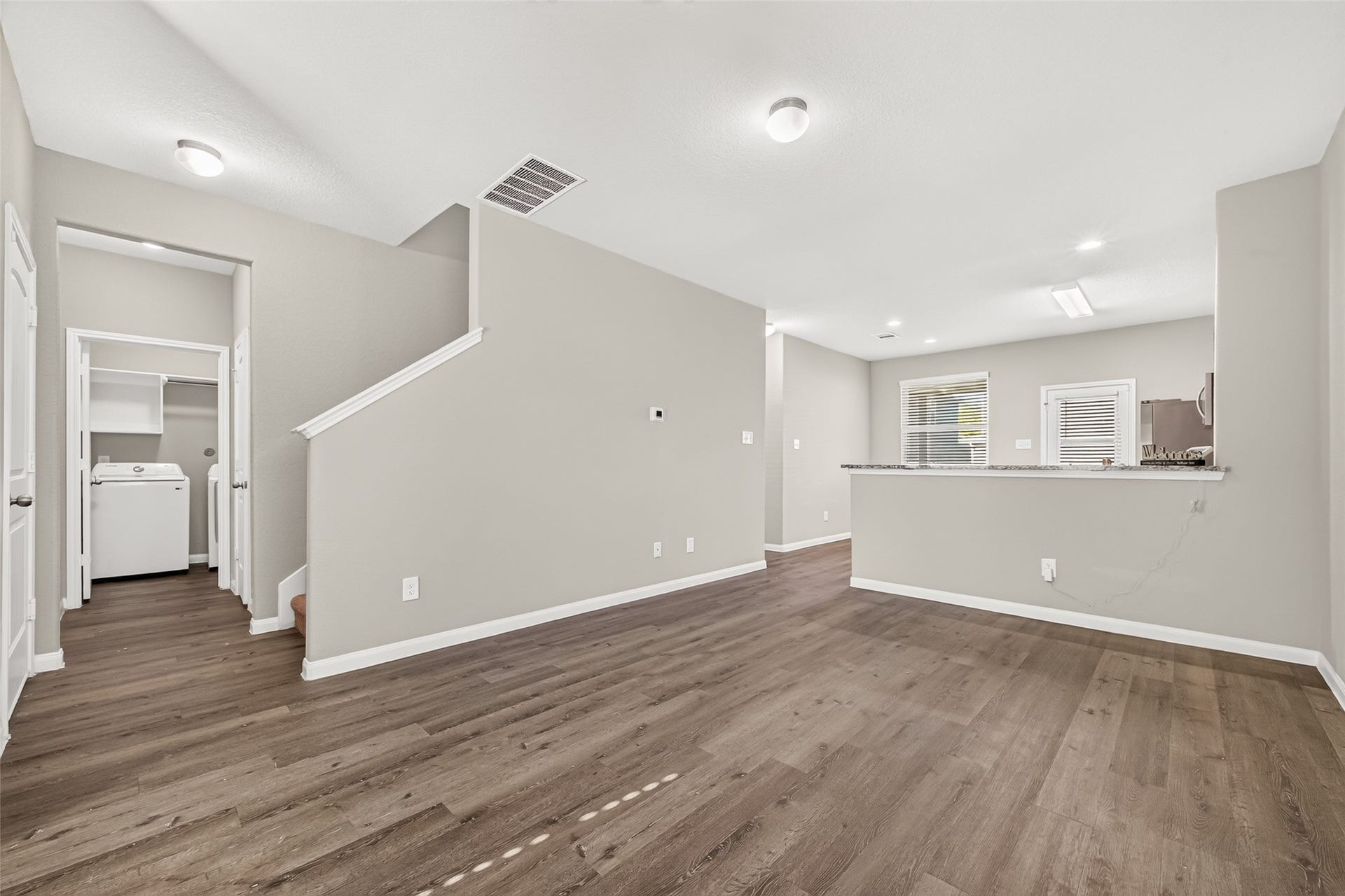 13405 Cannon Creek Court, Willis, TX 77378 Another view of your open living space with modern vinyl flooring, and a view of your kitchen featuring a sleek breakfast bar great for entertaining.