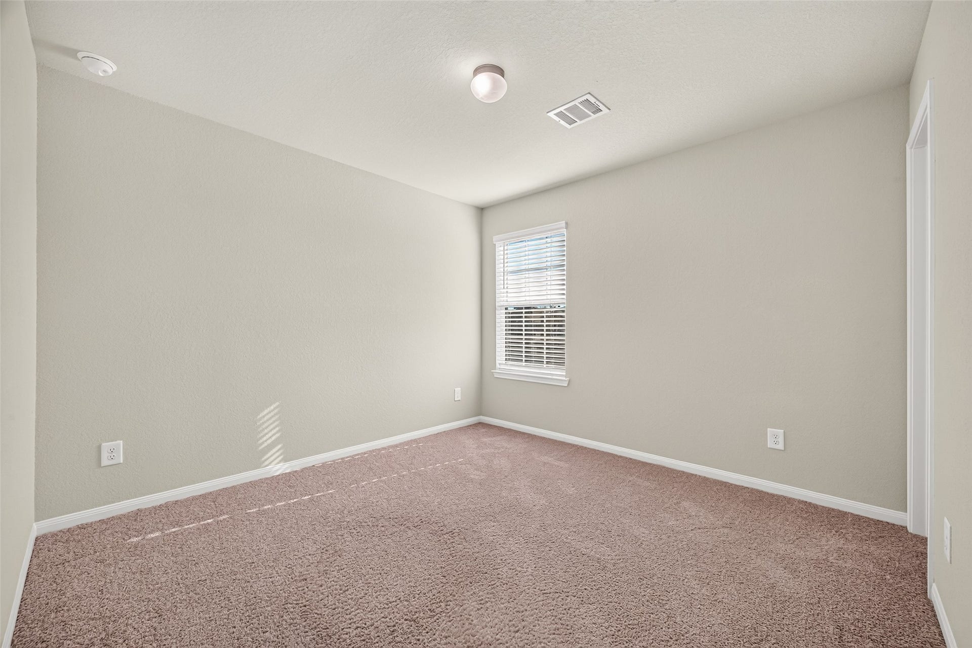13405 Cannon Creek Court, Willis, TX 77378 Bedroom 4 with plush carpet, neutral walls, and a bright window offering natural light.