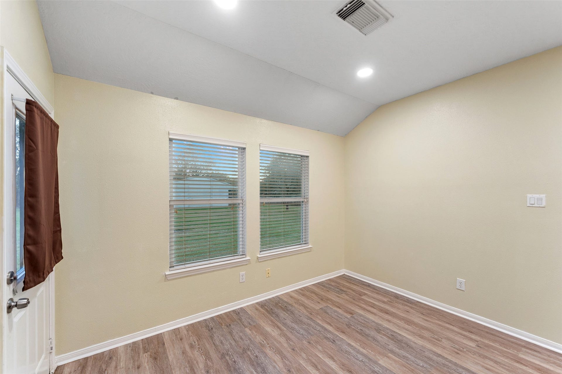 Bright breakfast nook just off the kitchen, featuring multiple windows and an ideal space for casual dining.