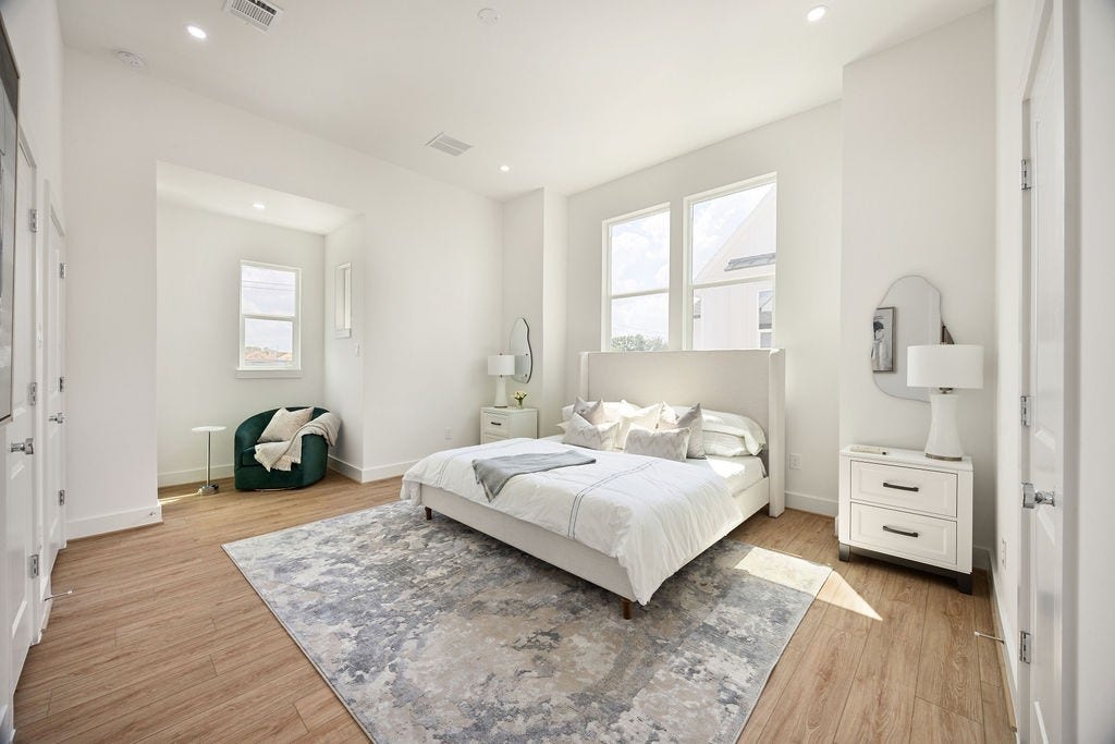Spacious primary suite filled with natural light, creating a bright and relaxing retreat.