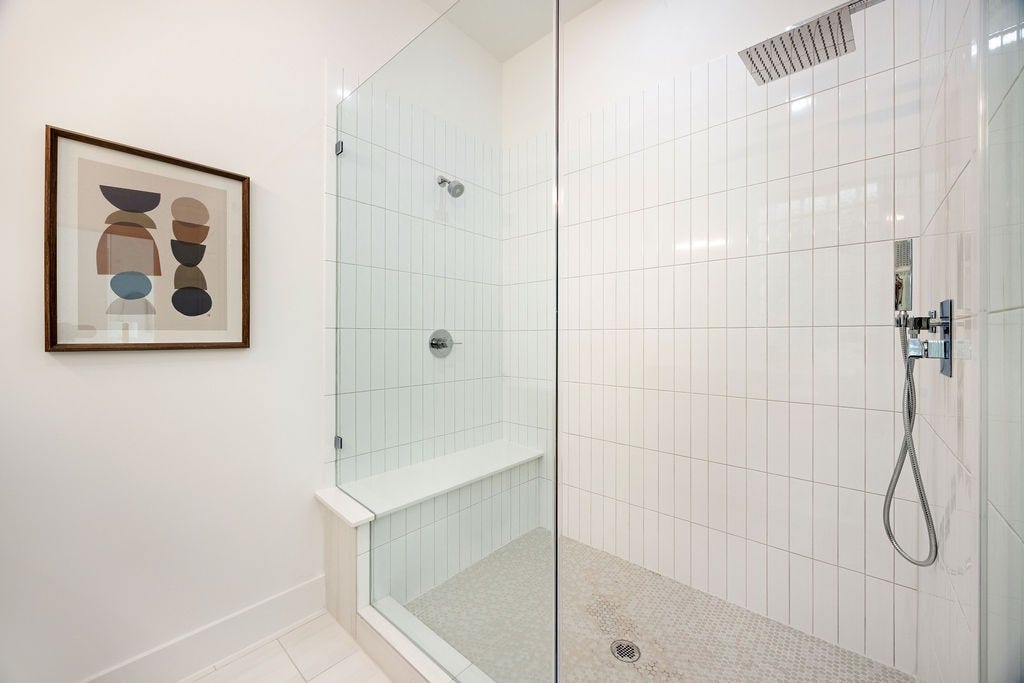 Oversized walk in shower with a sleek, modern design.