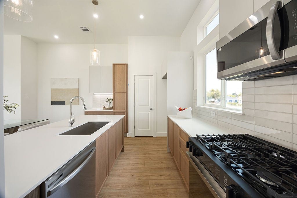 Thoughtfully designed kitchen with soft close cabinetry, two pantries, under cabinet lighting, and ample storage.