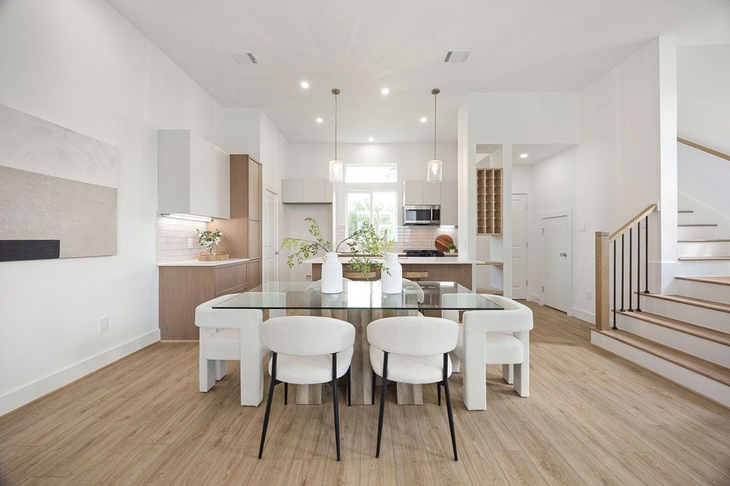 Open concept living and dining area accented by beautiful wood flooring.