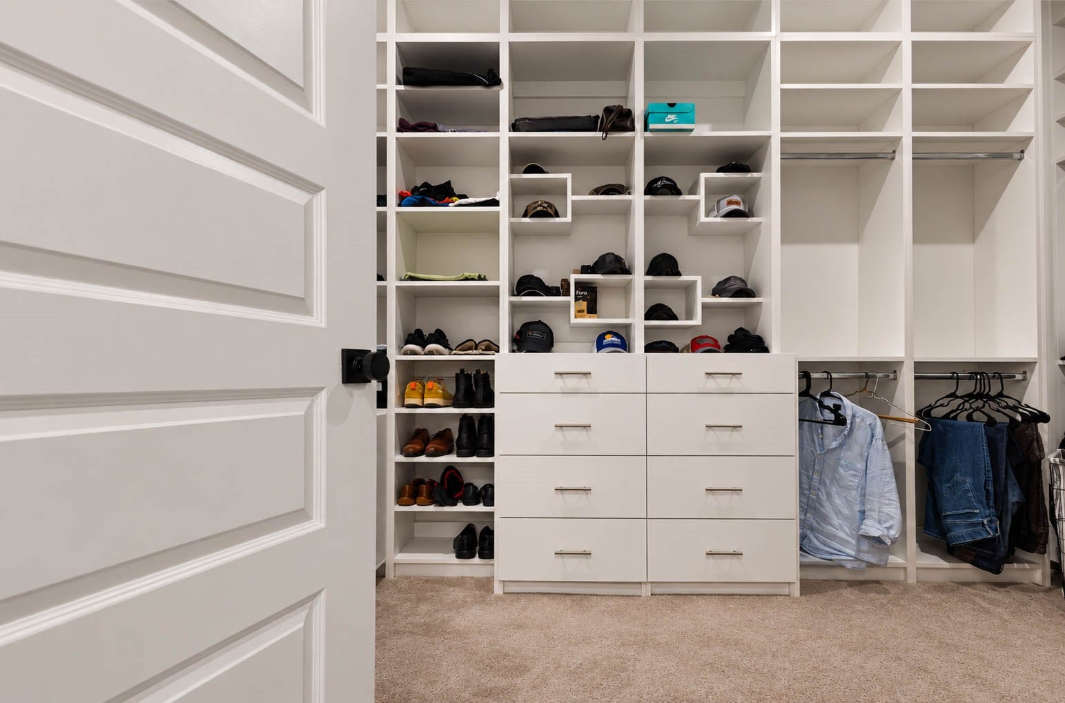 4839 Summer Place Court, Fulshear, TX 77441 Spacious custom built walk-in closet featuring shelving, ample storage drawers, and dedicated hanging space for organized living.