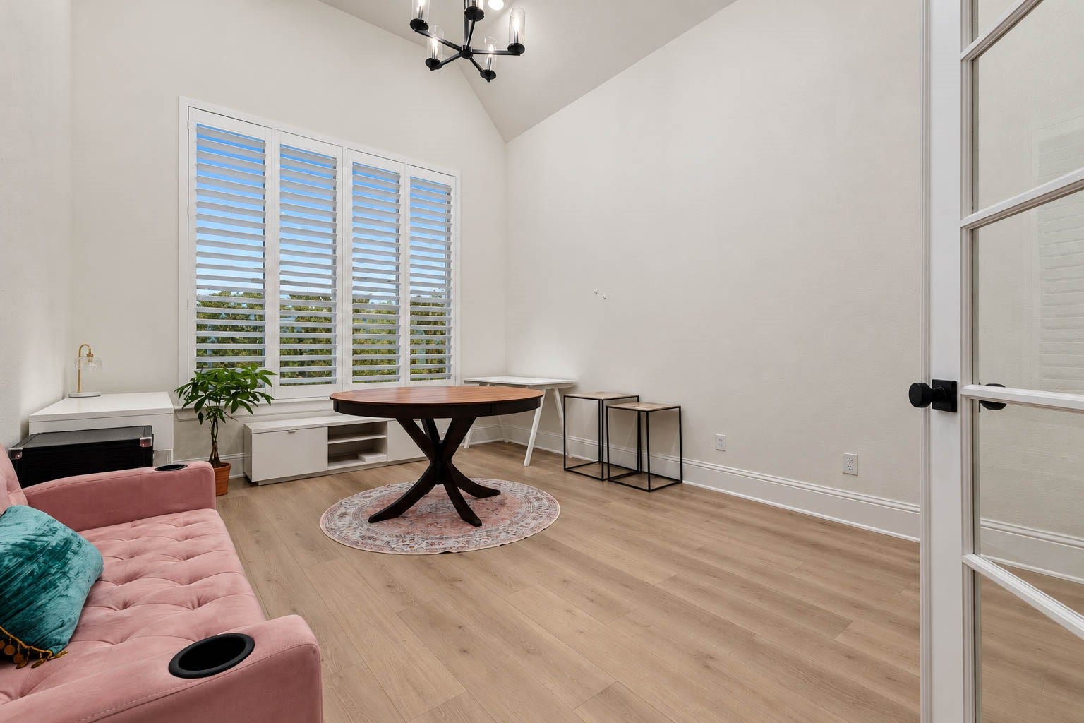 4839 Summer Place Court, Fulshear, TX 77441 Charming home office space with high ceilings, featuring elegant wood flooring and abundant natural light streaming through large plantation shutters. Enclosed by glass french doors.