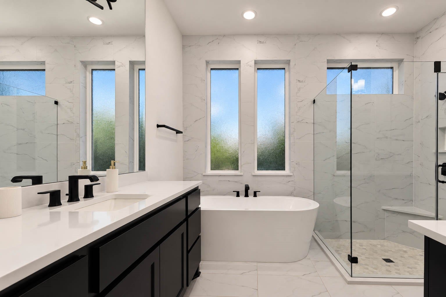 4839 Summer Place Court, Fulshear, TX 77441 Elegant primary bathroom featuring a freestanding soaking tub, sleek glass shower, and modern black fixtures, complemented by marble-patterned tiles and abundant natural light through tall windows.
