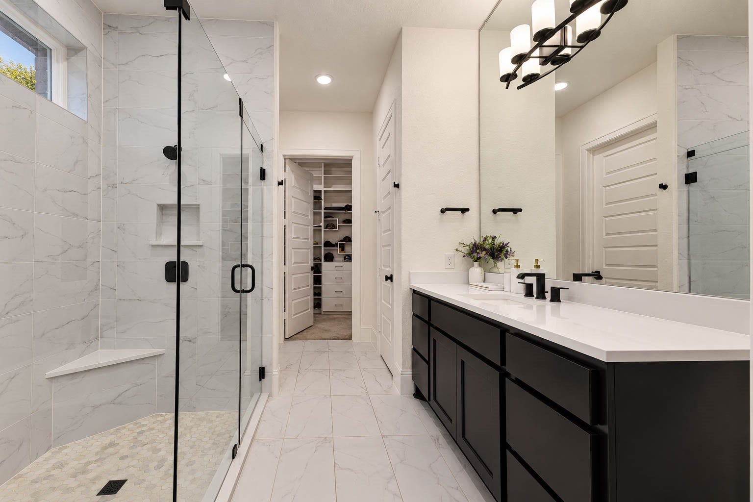 4839 Summer Place Court, Fulshear, TX 77441 Elegant bathroom featuring a spacious glass-enclosed super shower with marble-like tile, a sleek double vanity with modern fixtures, and access to a convenient walk-in closet.