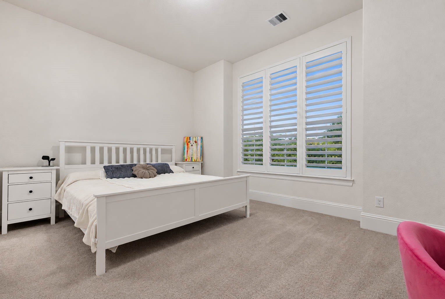 4839 Summer Place Court, Fulshear, TX 77441 Bright and inviting bedroom at the front of the house, ample natural light from large windows with shutters, and neutral tones for a serene atmosphere.