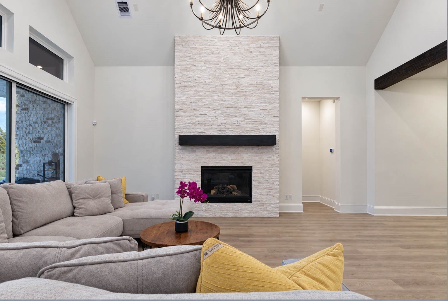 4839 Summer Place Court, Fulshear, TX 77441 Bright and inviting living room featuring a stunning stone fireplace, high ceilings, and large windows that fill the space with natural light.