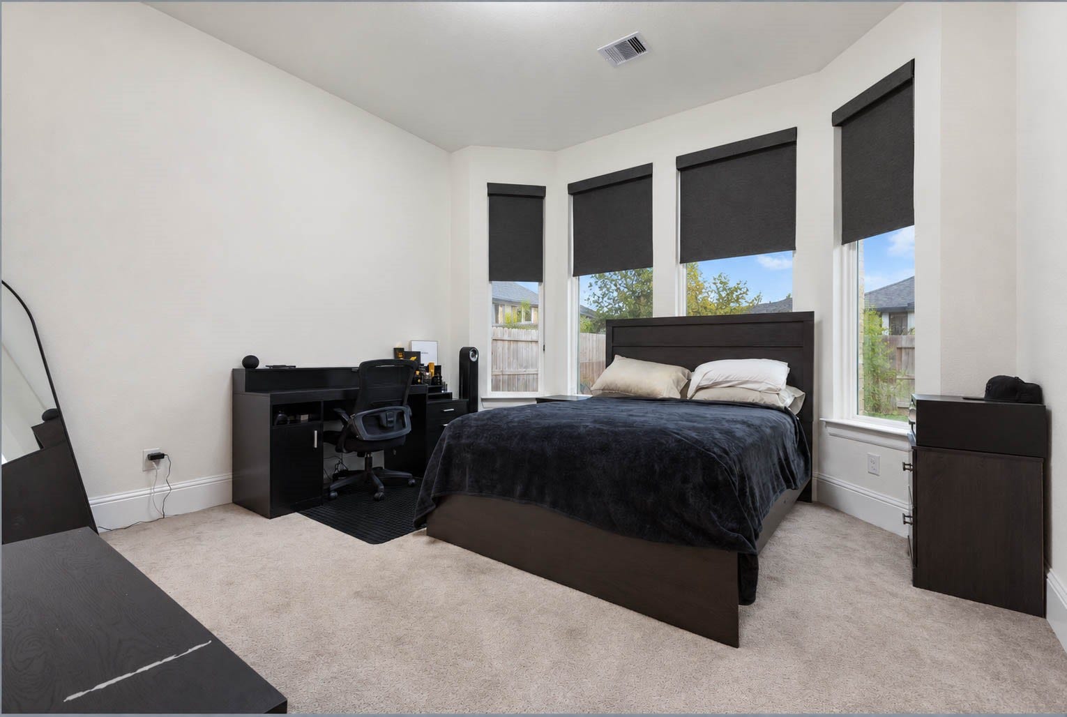 4839 Summer Place Court, Fulshear, TX 77441 Spacious bedroom with large windows with shades, offering ample natural light. Complemented with an in suite bathroom