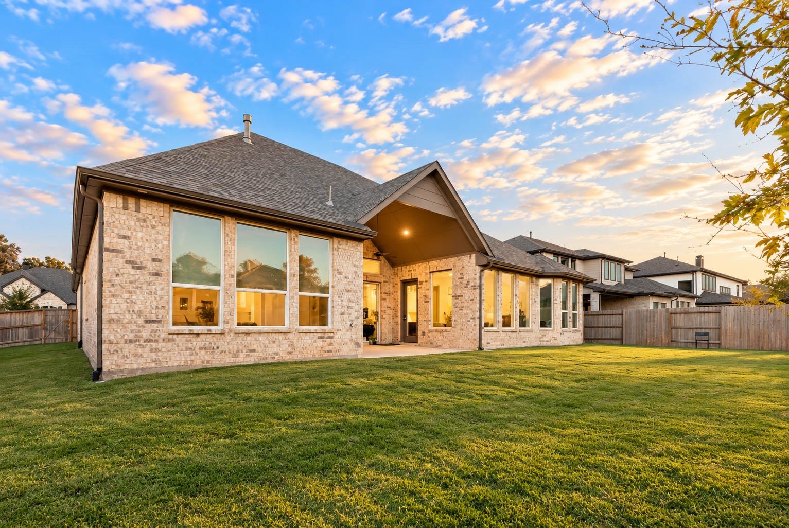 4839 Summer Place Court, Fulshear, TX 77441 Charming brick home with expansive windows and a spacious backyard, perfect for enjoying sunsets and outdoor gatherings.