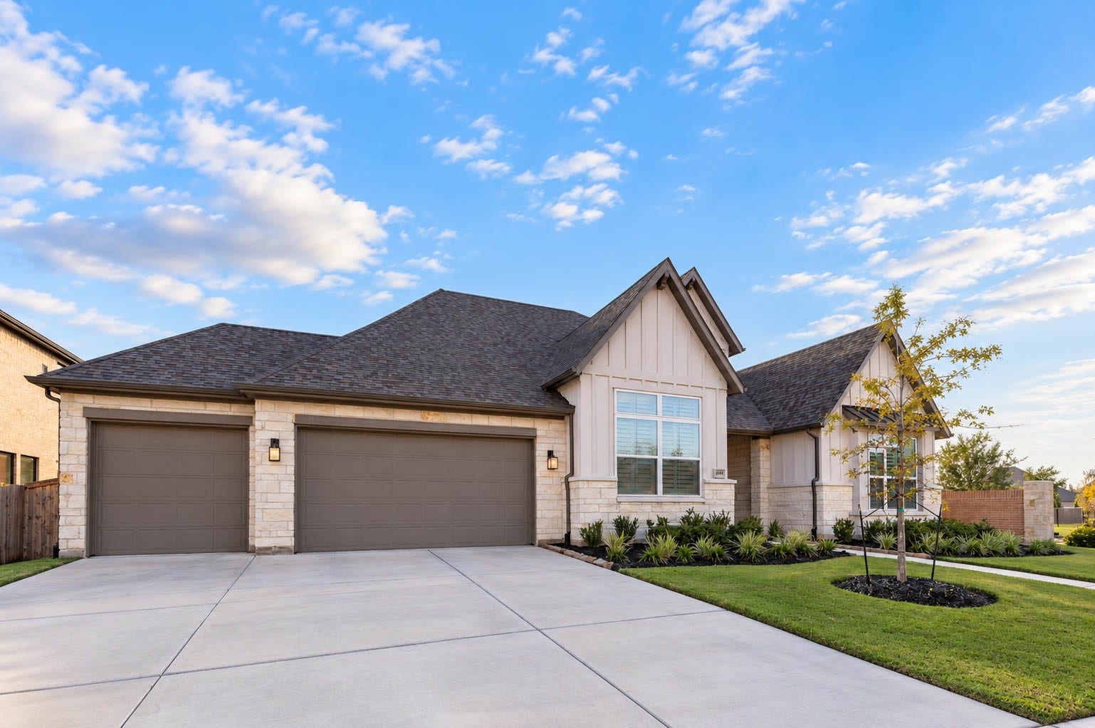4839 Summer Place Court, Fulshear, TX 77441 Charming single-story home with a stone and stucco facade, featuring a spacious three-car garage and beautifully landscaped front yard.